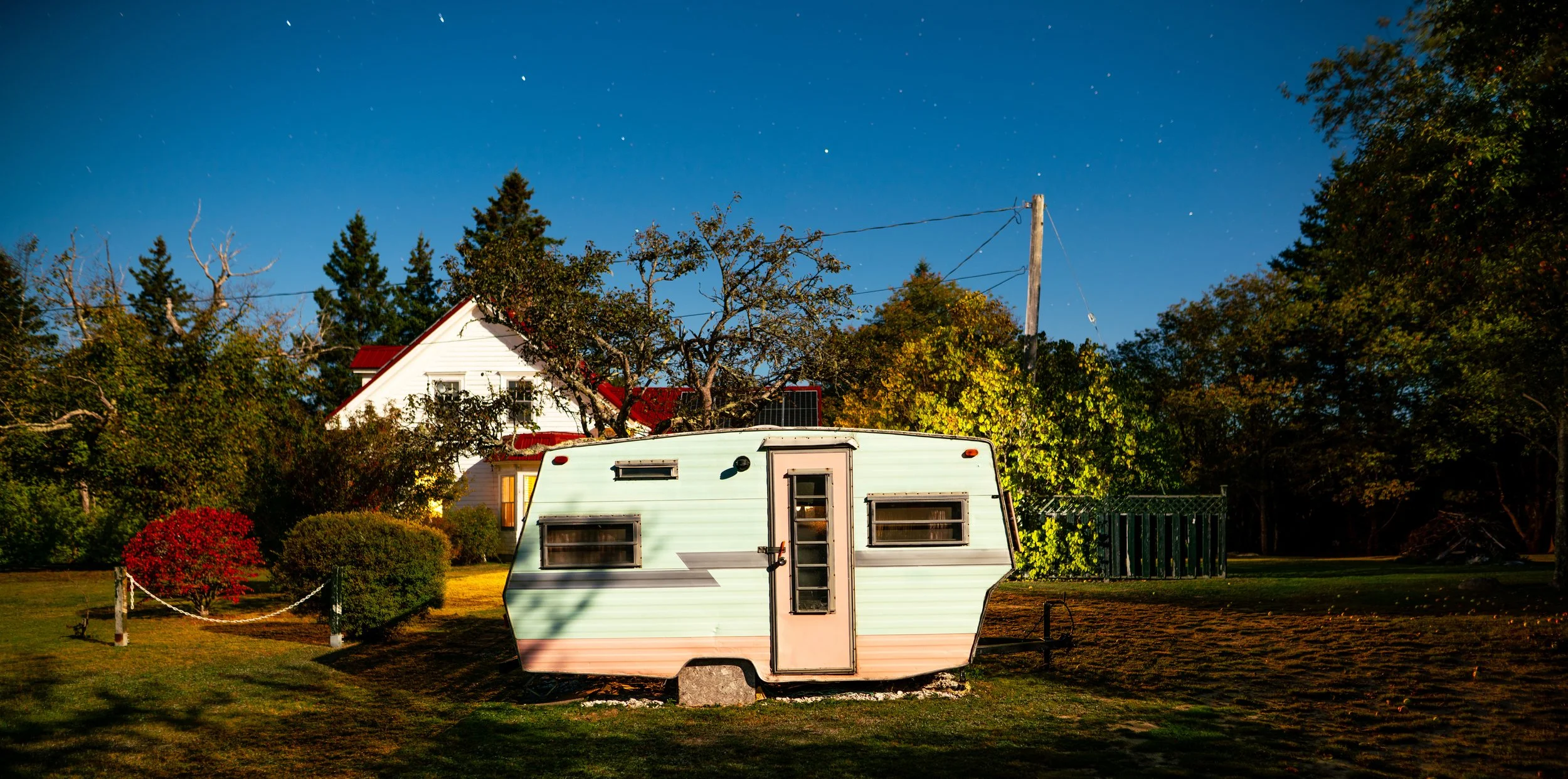 Homestead with retro vintage trailer long exposure