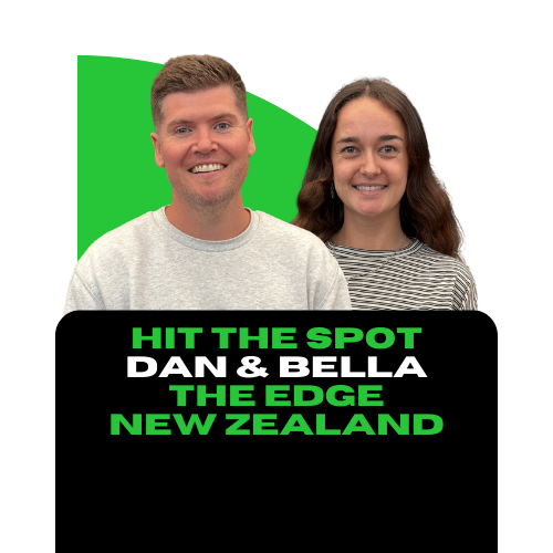 Two people, a man with short light brown hair and a woman with long dark brown hair, smiling, standing in front of a colorful background with text promoting a show called 'Hit the Spot' with Dan & Bella from New Zealand.