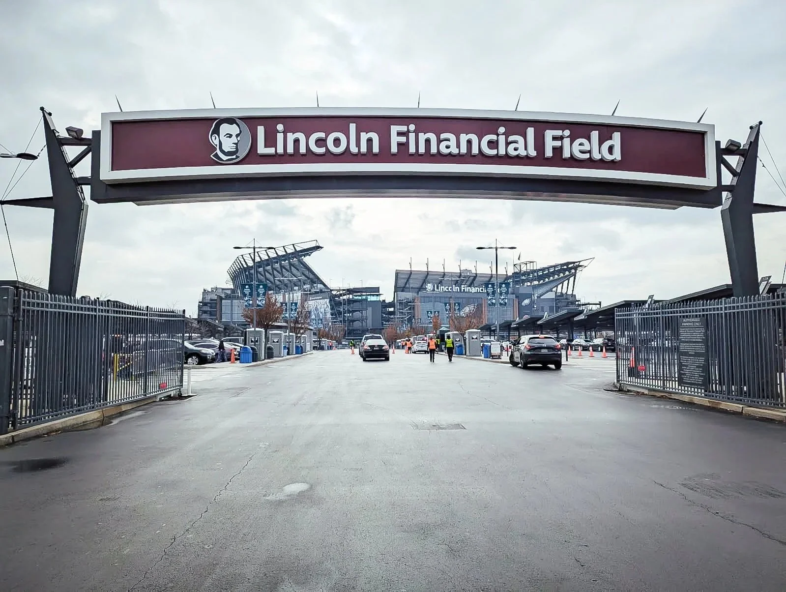 Entrance gate to Lincoln Financial Field with parking lot and stadium in the background.