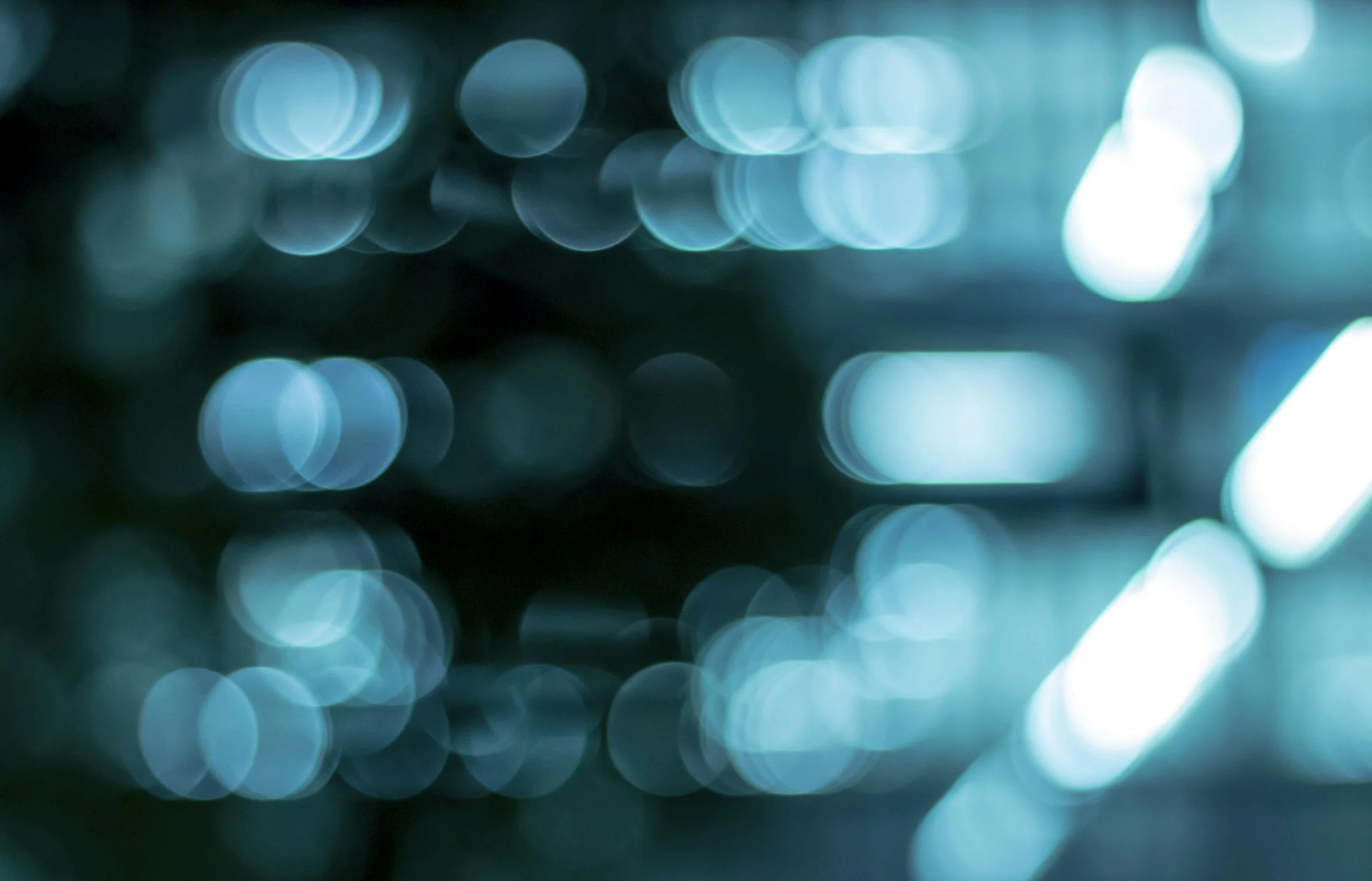 Blurred blue and white circular lights creating a bokeh effect.