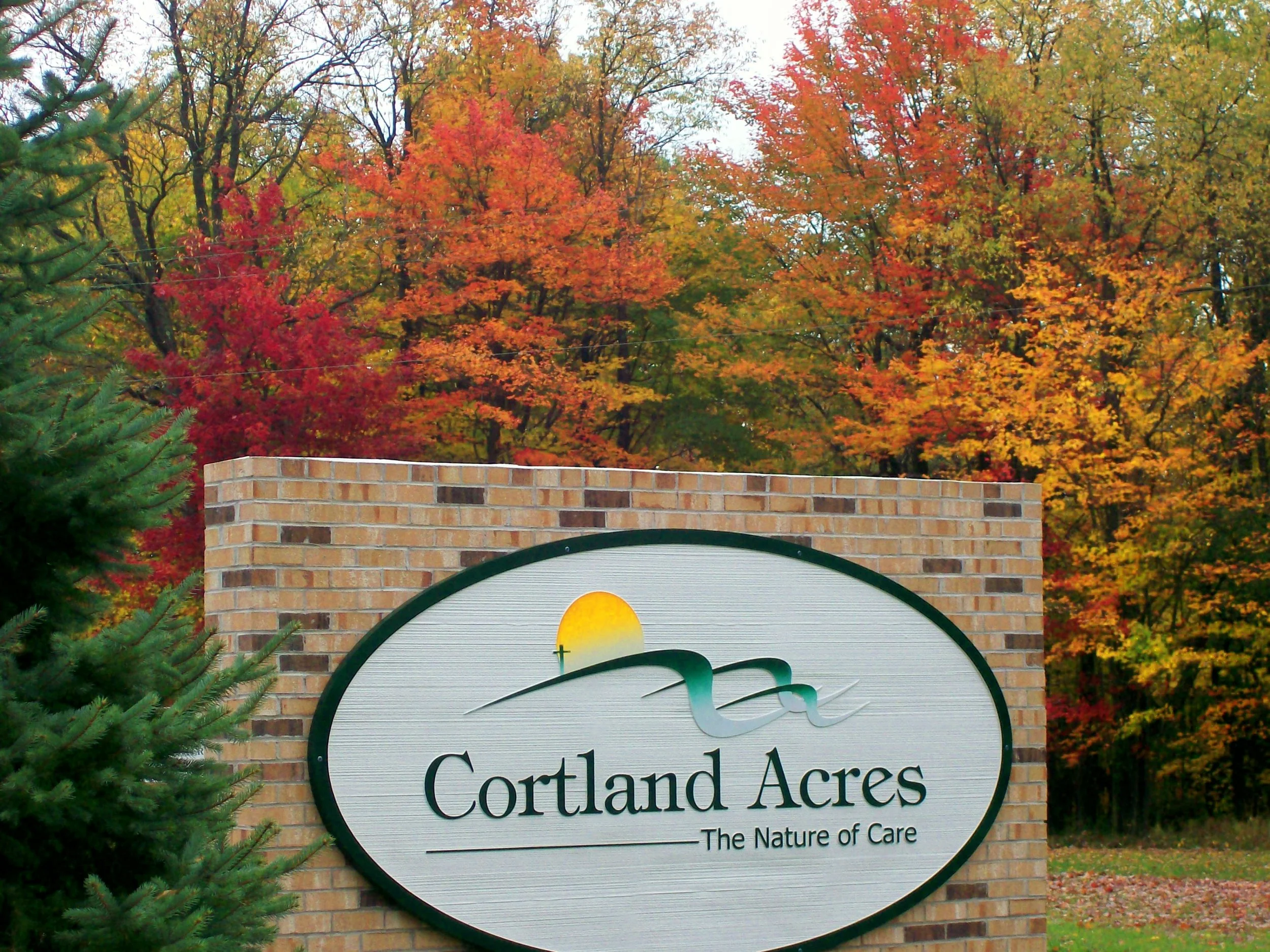 Original sign for Cortland Acres campus before the rebranding to Blackwater Ridge, with colorful autumn trees in the background.
