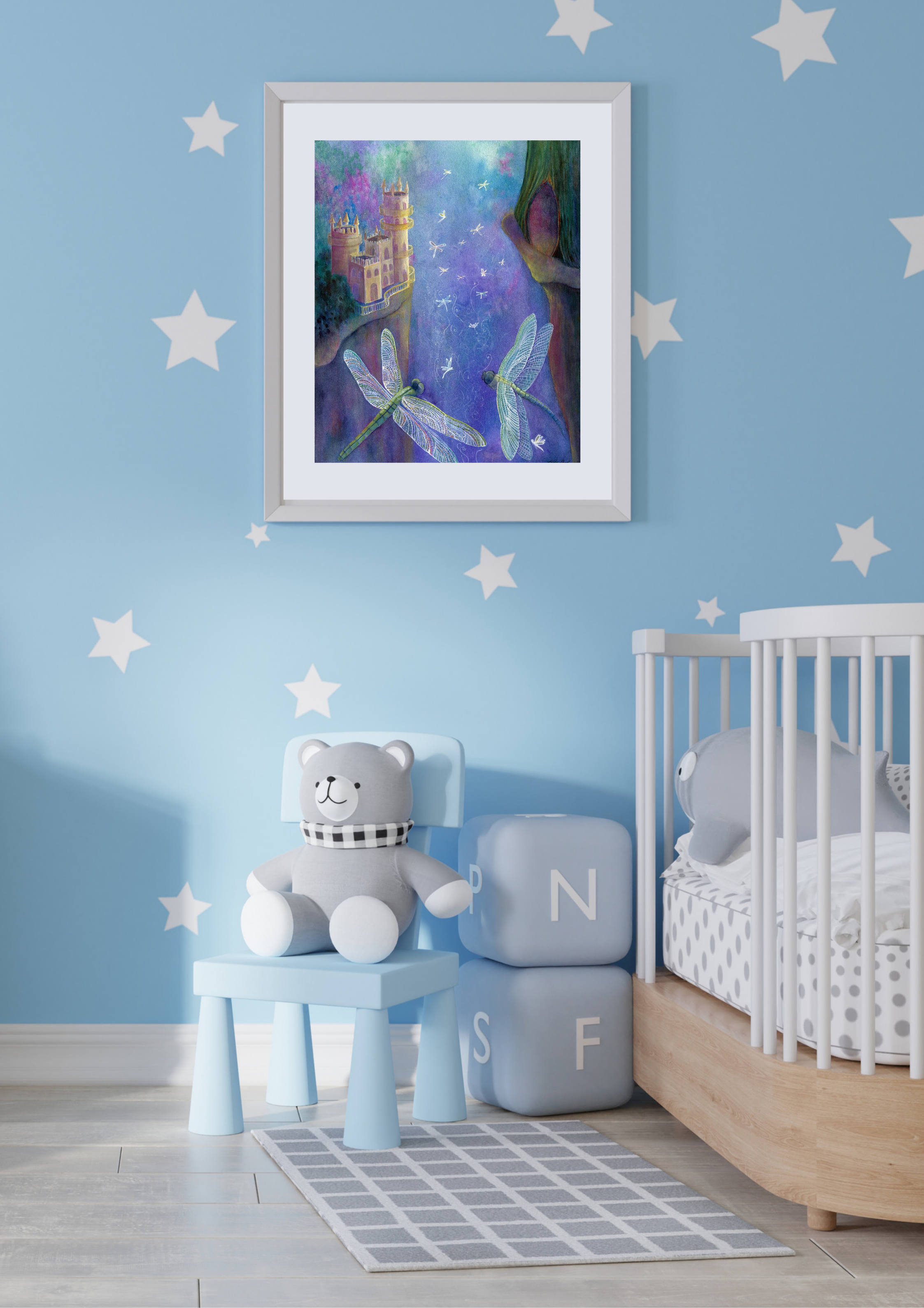 Dragonfly Cavern framed fantasy art print hanging in a soft blue children's nursery with a cot and teddy bear