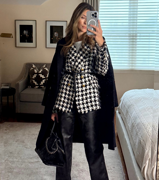 Alex wearing a Black and white coat.