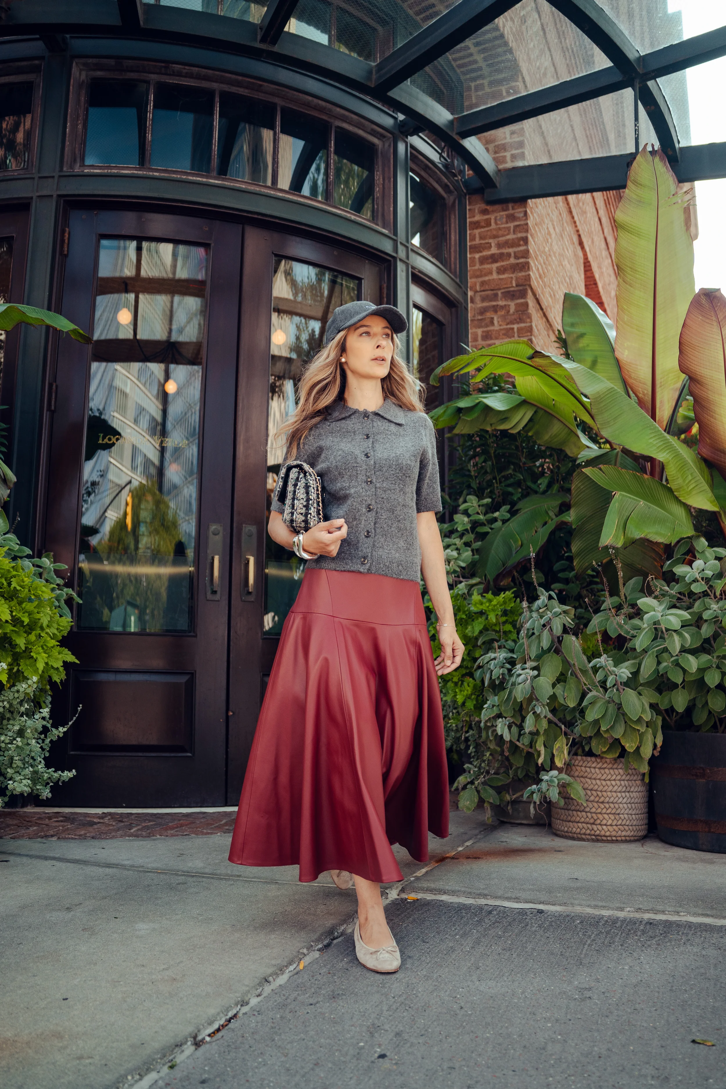 Alex styled in a red skirt, reflecting calm and confident personal style