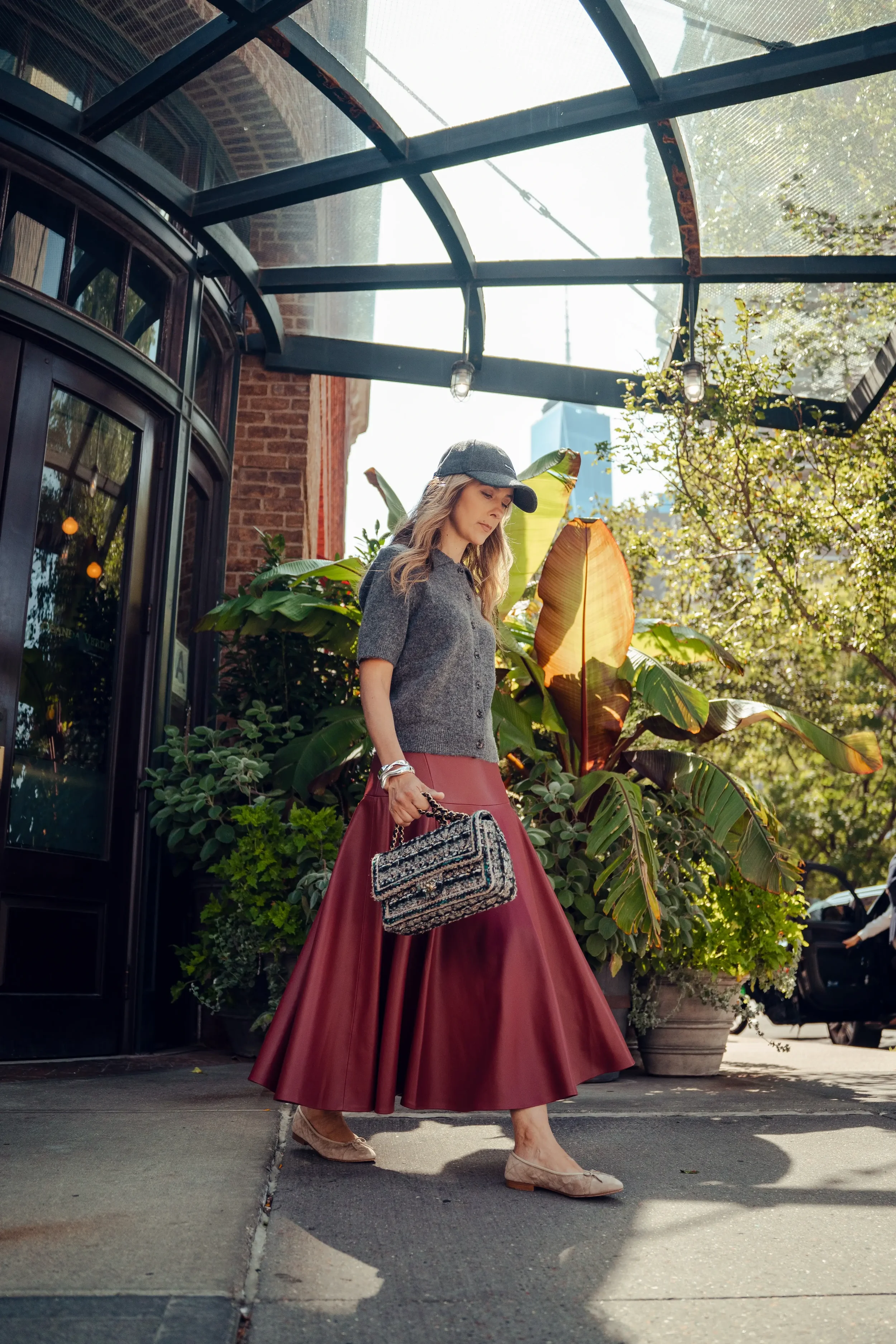 Alex styled in a red skirt, reflecting calm and confident personal style