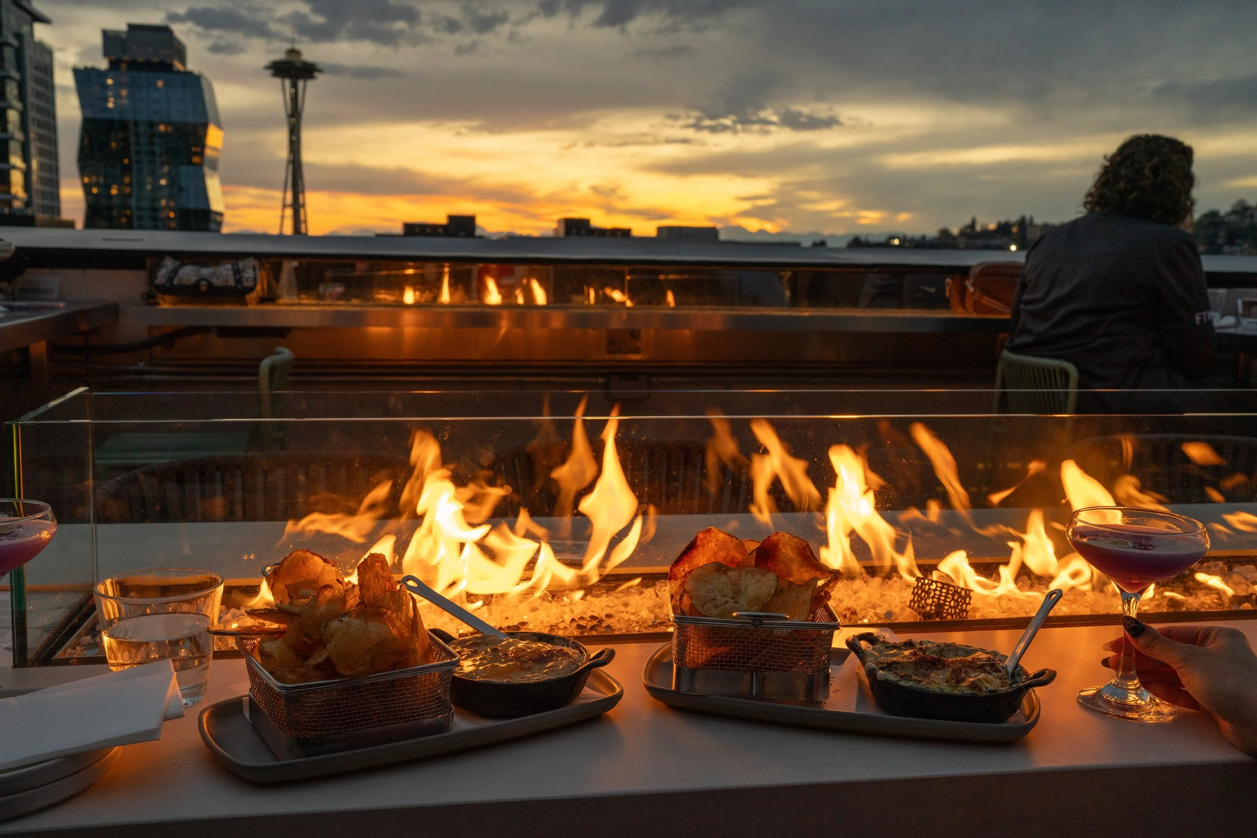 Rooftop fire pit at sunset with Space Needle view, Seattle Washington
