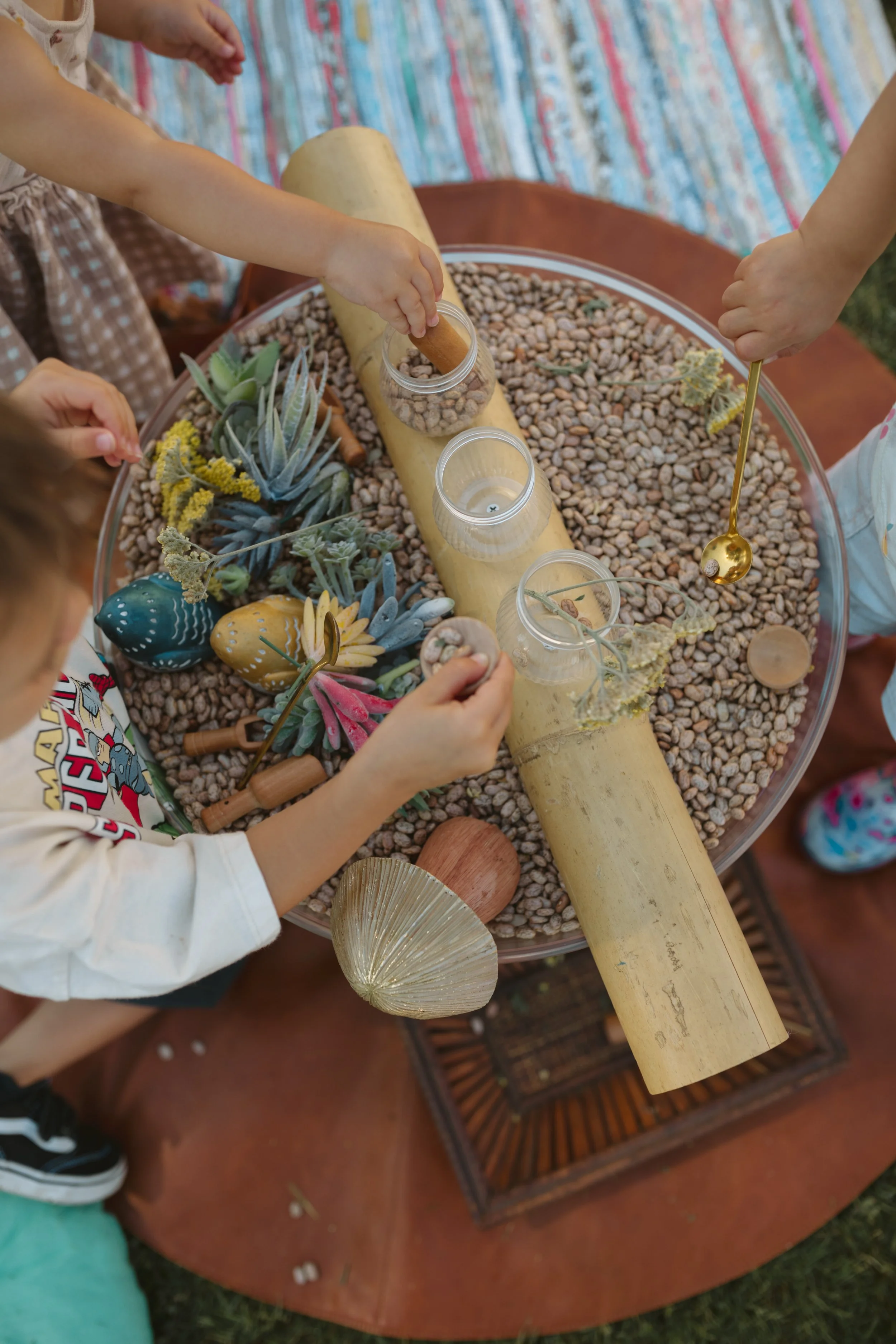 child plays with sensory materials outside
