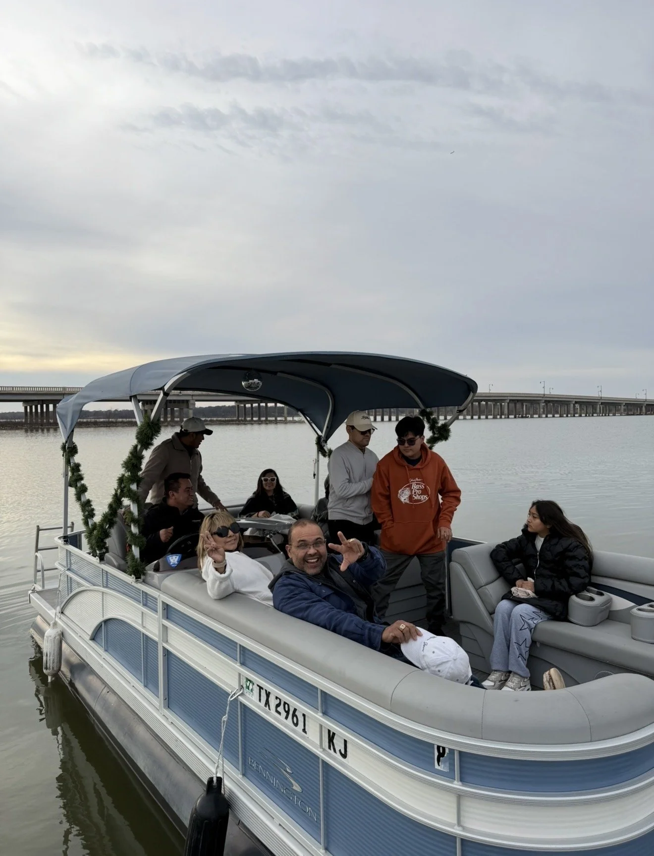 Group relaxing with drinks and snacks on a BoatByVal pontoon during a lake outing