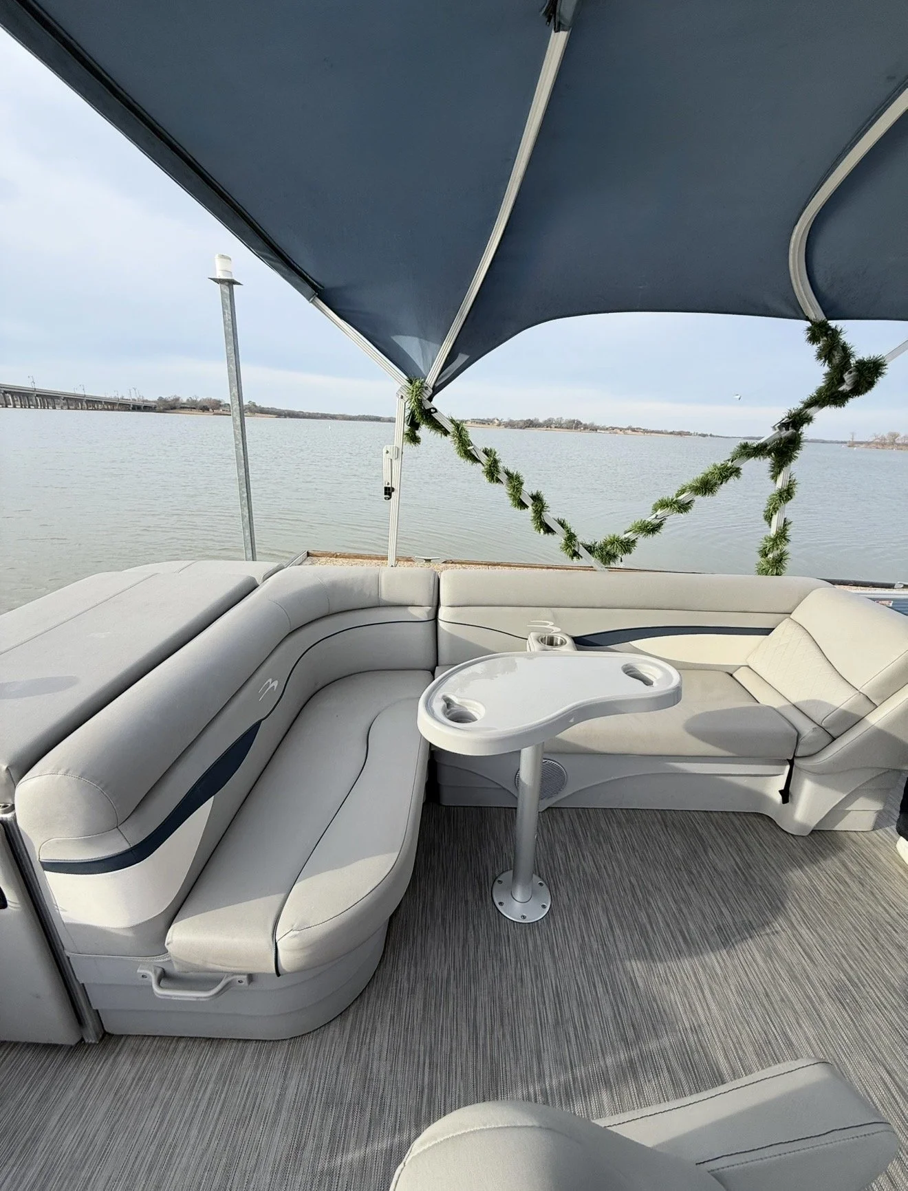 Interior drink table and seating on BoatByVal pontoon boat on Lake Lewisville