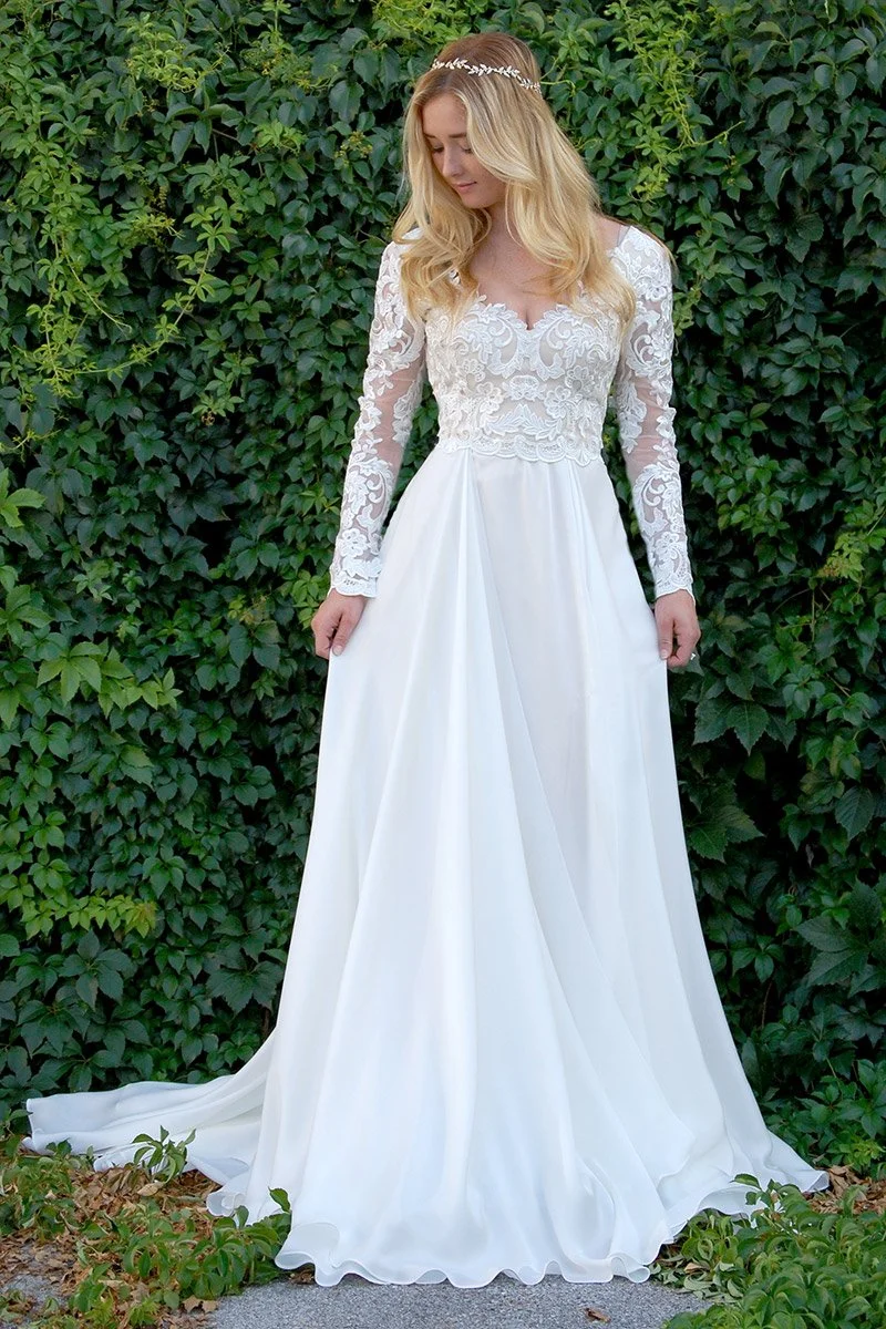 A bride in a garden setting wearing a beautiful silk gown