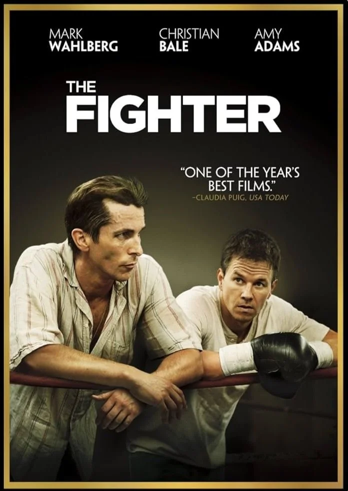 Movie poster for 'The Fighter' featuring Mark Wahlberg and Christian Bale in a boxing gym. Mark Wahlberg with his arm around Christian Bale, who is wearing boxing gloves.
