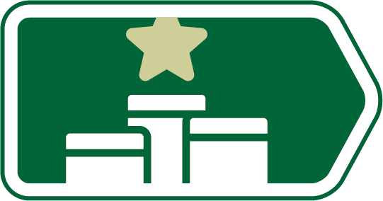 Green road sign with white arrow pointing right, featuring a yellow star and three white gift box icons underneath.