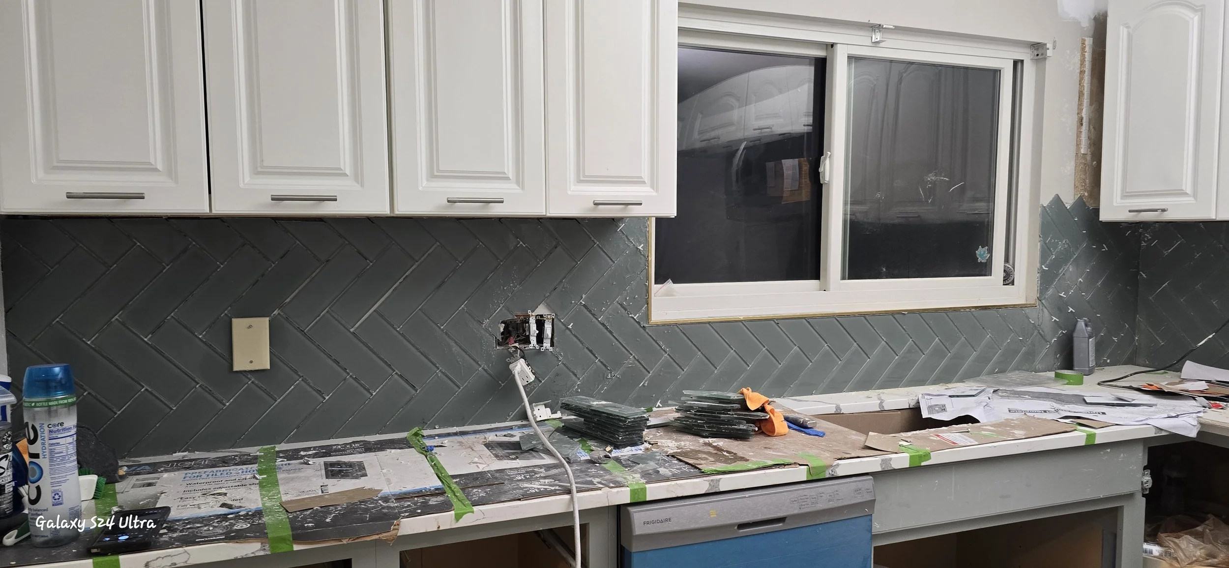 A St. Louis kitchen backsplash with subway tiles installed in a herringbone pattern.