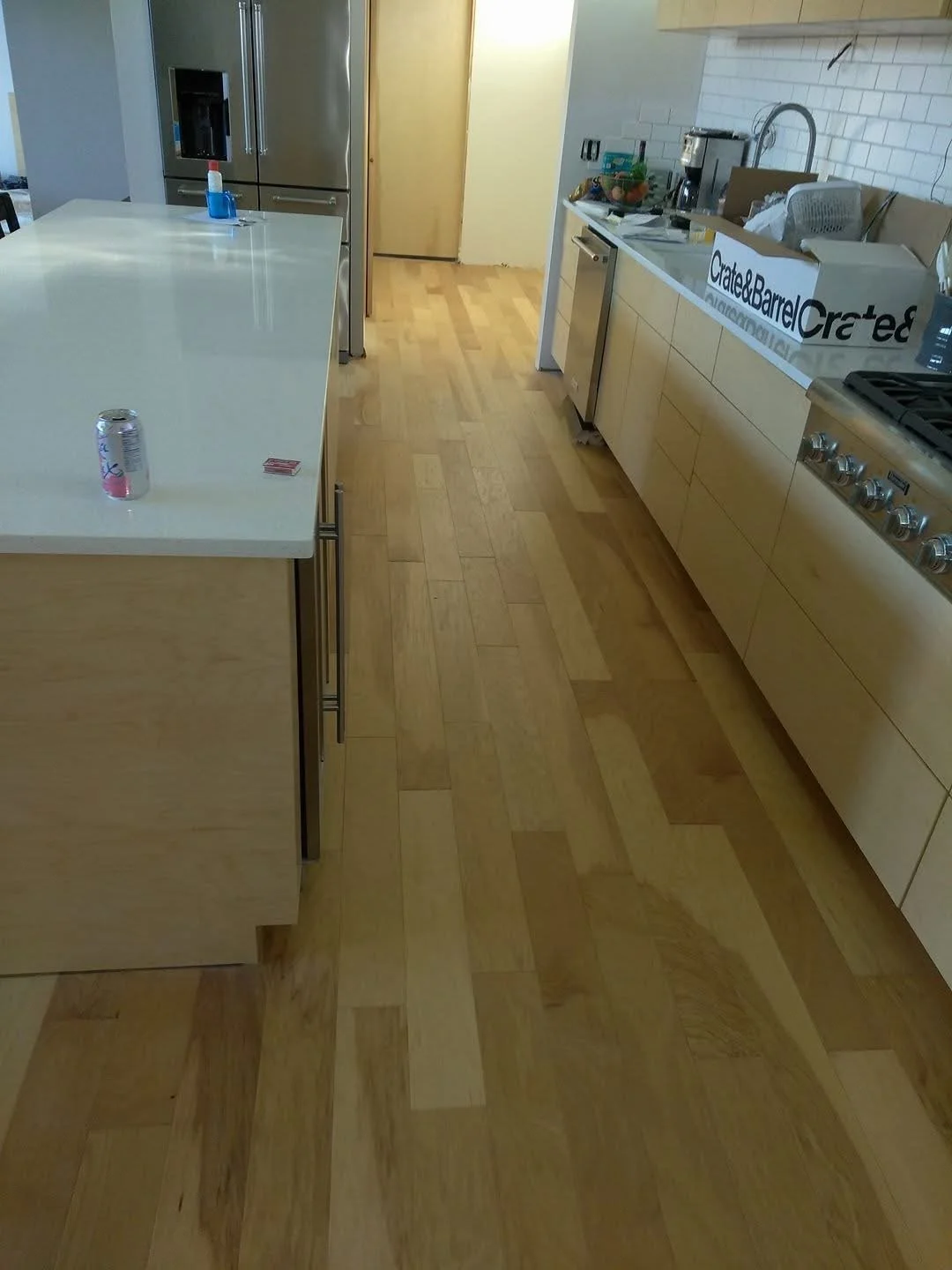Hardwood installation in kitchen with straight, consistent board alignment and a smooth finish. 