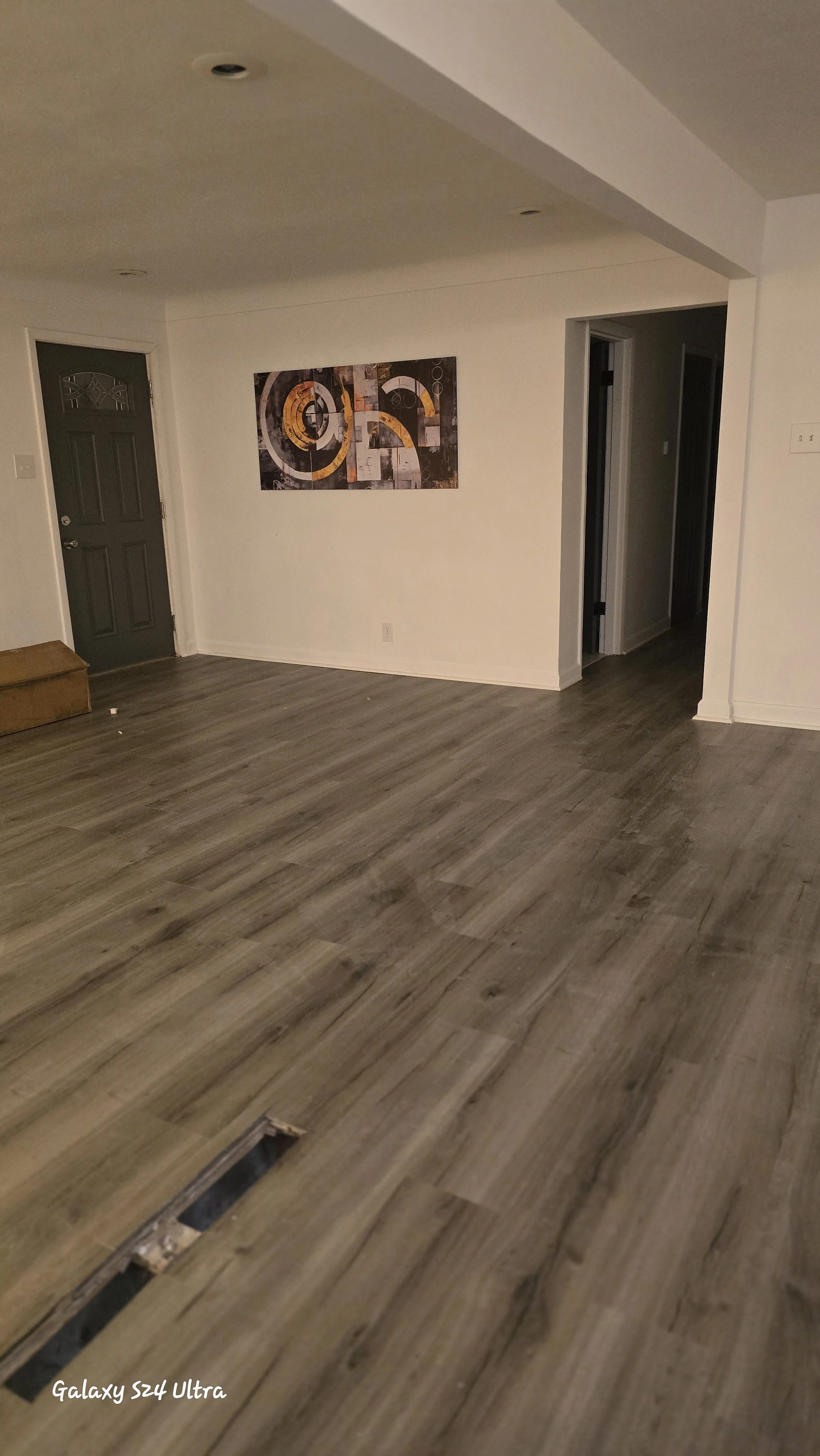 Luxury vinyl plank installed with tight, seamless joints, creating a clean and modern look throughout the space.