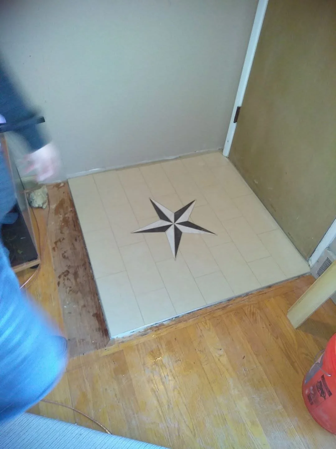 A custom style star created in a tile layout in the entry way. 