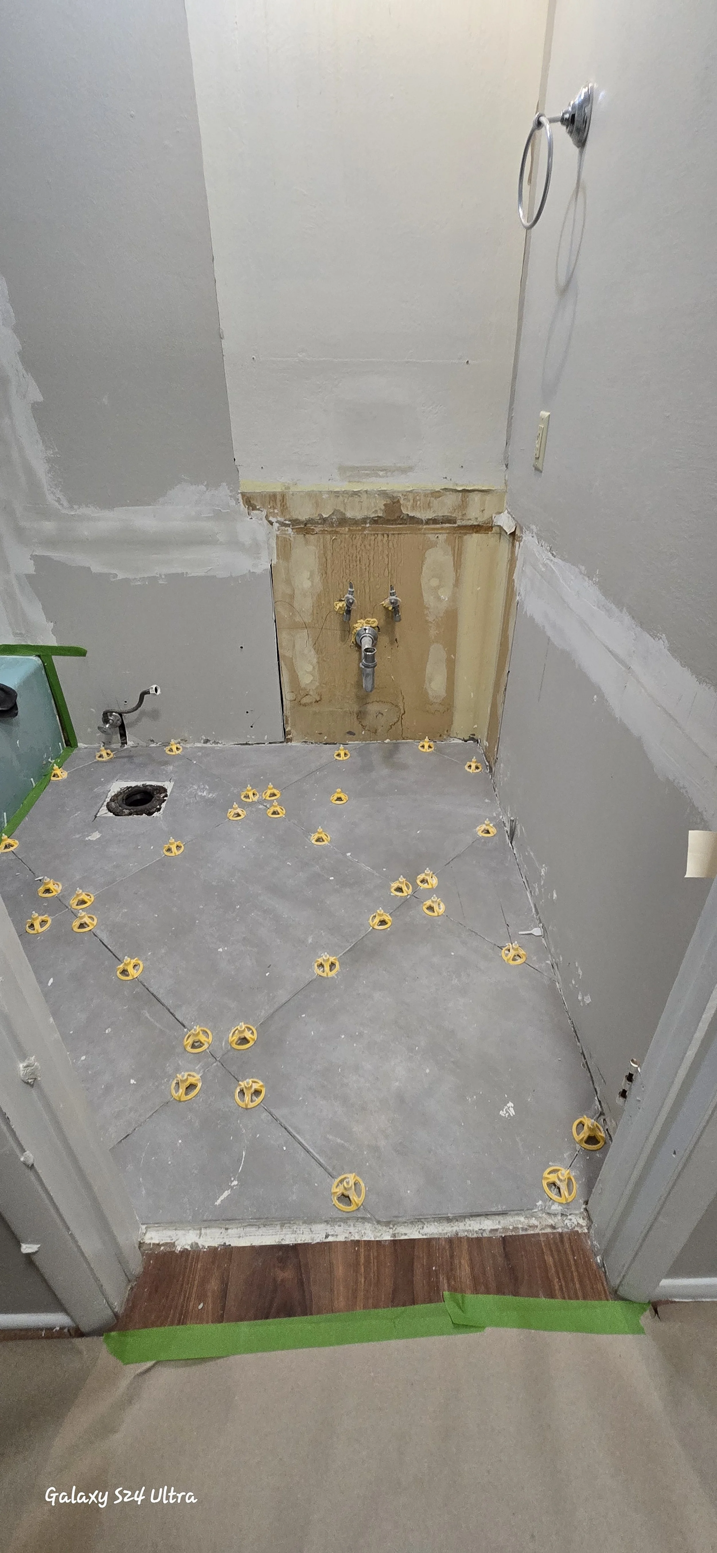 Bathroom remodel new tile floors being installed. 