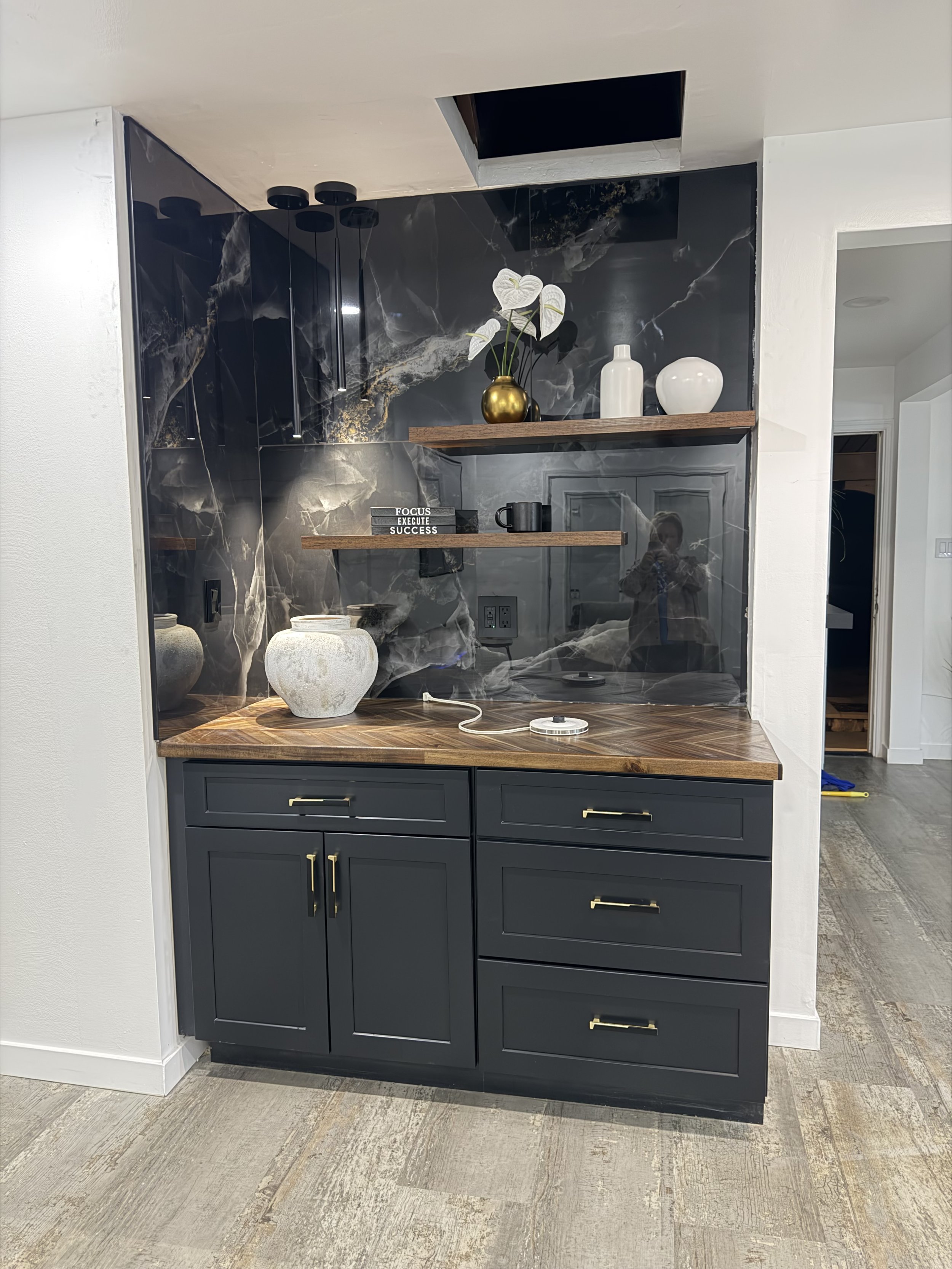 Installed black ceramic tile wall, shelves, cabinets, and sanded and stained countertop in a new home remodel in Florrisant, Mo. 