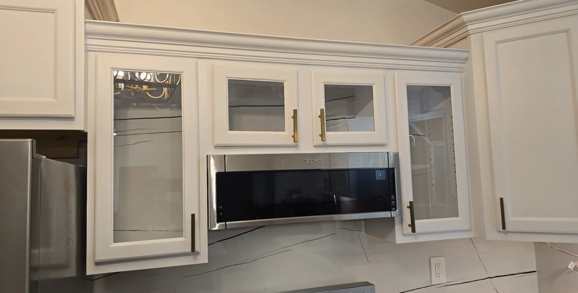 Custom cabinets with glass fronts and tile background as well as backsplash installed.                                                                                                                                                                 