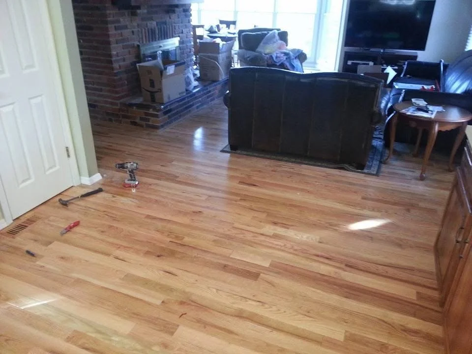 Hardwood installation connecting multiple rooms with a level, smooth finish. 