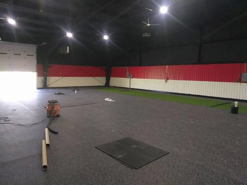 Heavy-duty rubber flooring installed in a gym area for improved durability and noise reduction. 