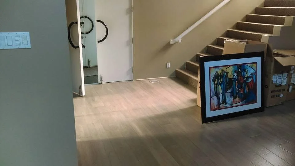 Hardwood flooring installed in entry way with precise cuts and seamless transitions between rooms. 