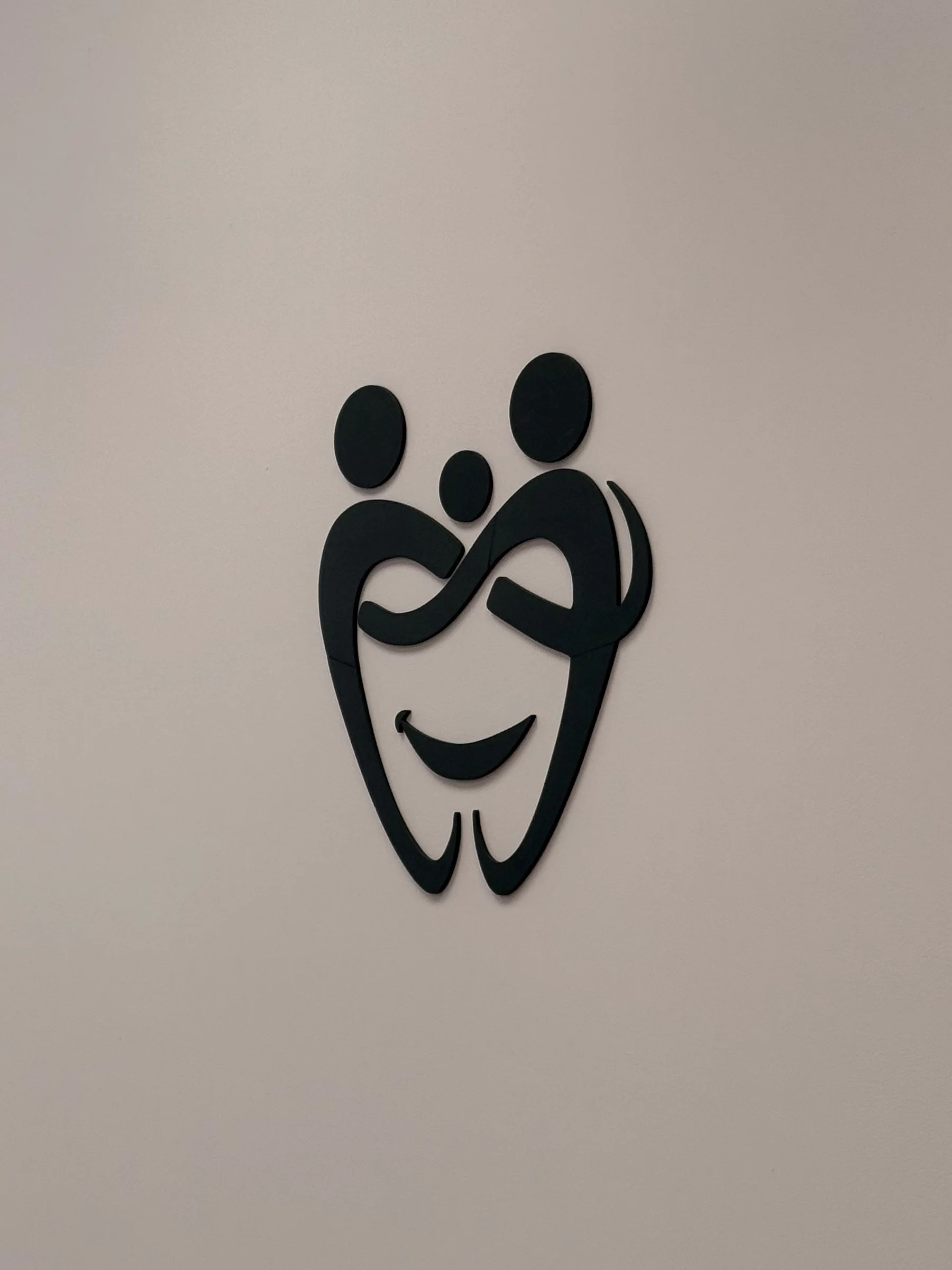 Decorative wall art featuring two stylized teeth, a toothpick, and a smiling mouth.