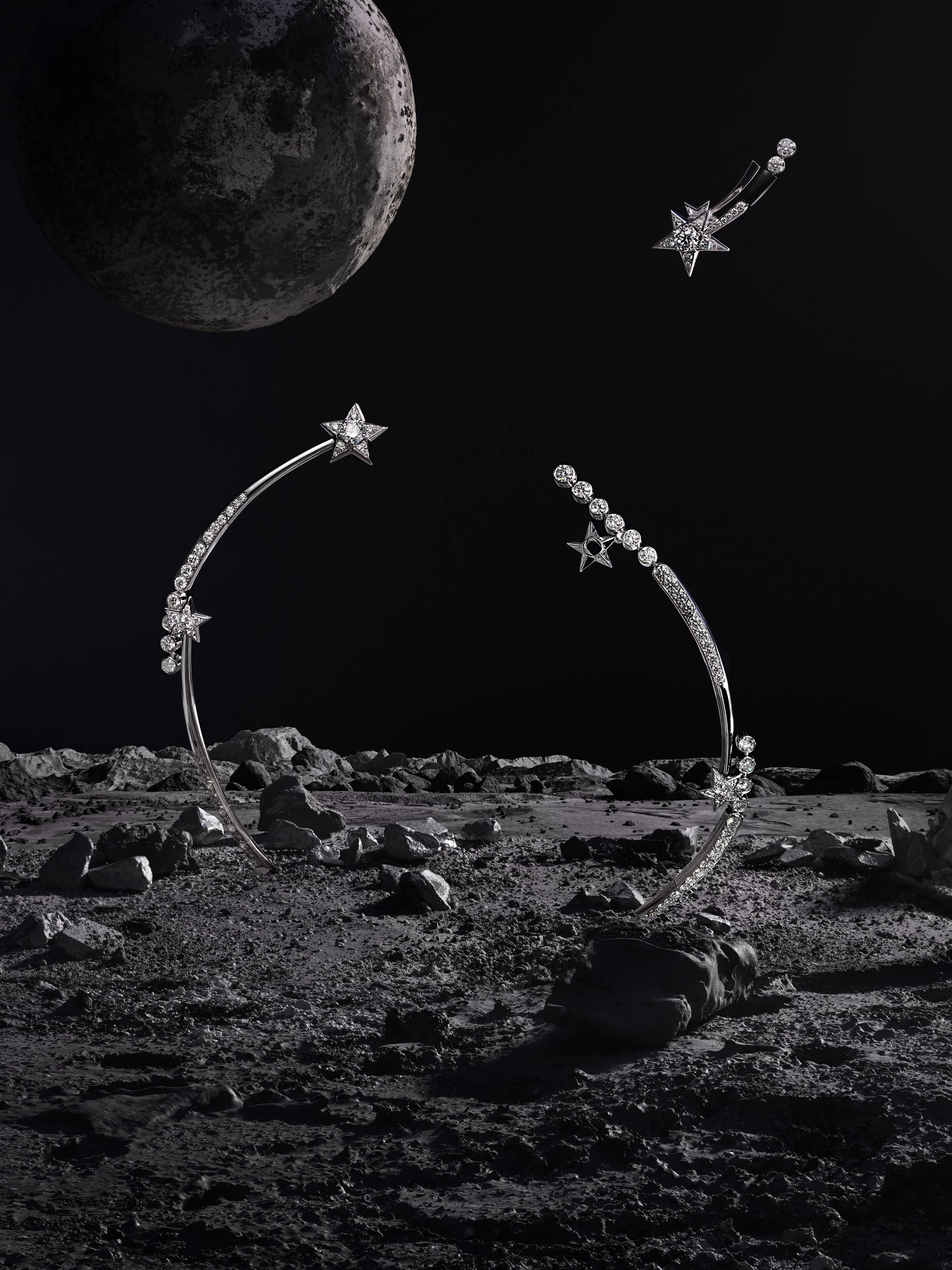 Silver moon-shaped jewelry with star and diamond accents floating above a lunar landscape with rocks, with the moon in the background.