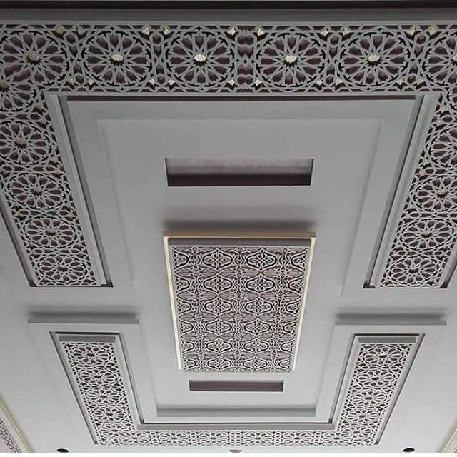 Techo decorativo con patrones geométricos y detalles ornamentales en tonos claros.