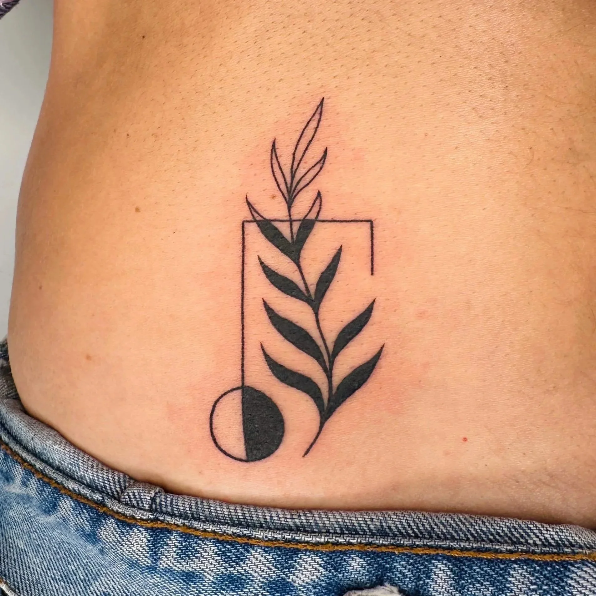Botanical leafy tattoo intersecting with geometric