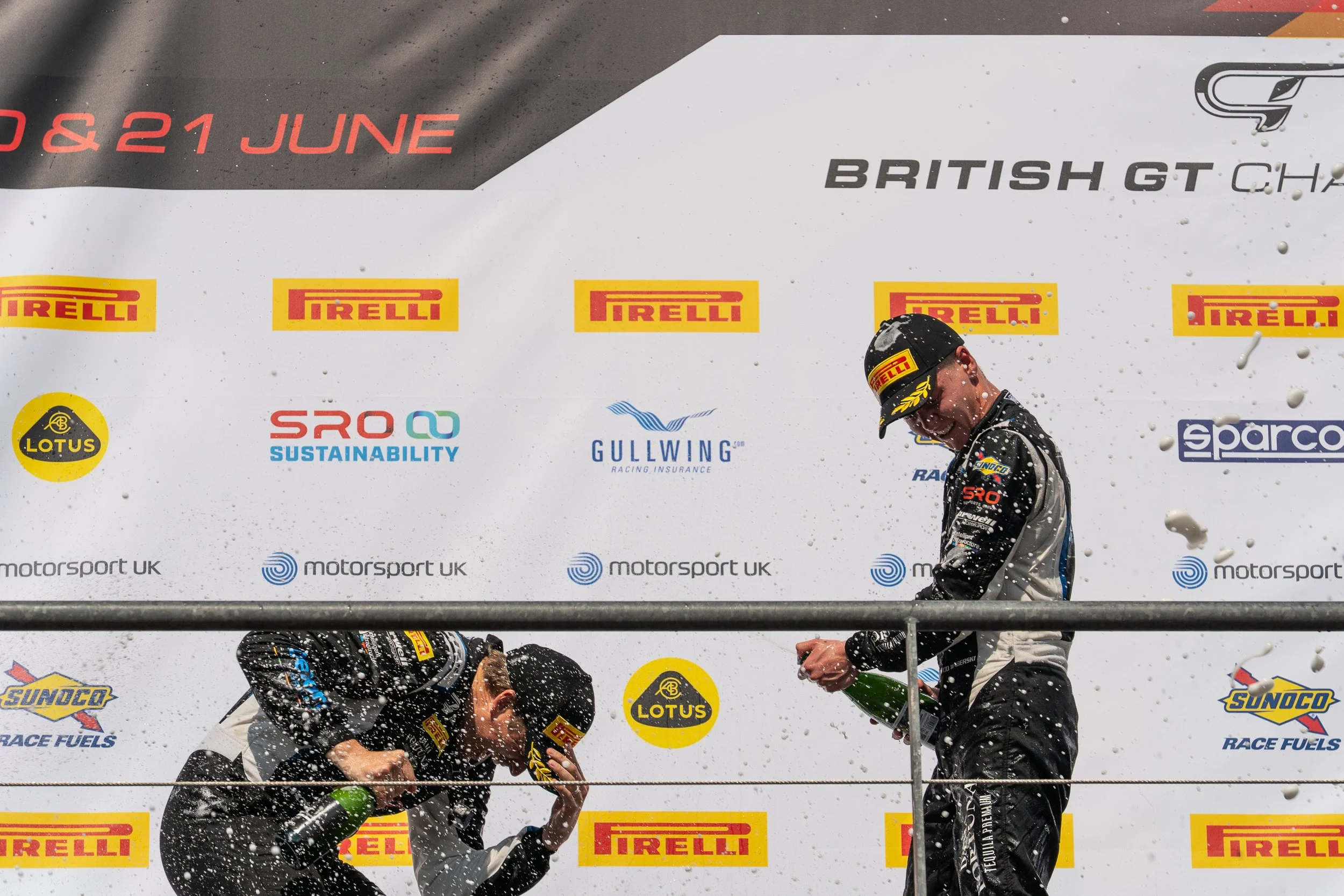 British GT drivers spraying champagne on the podium at Circuit de Spa-Francorchamps