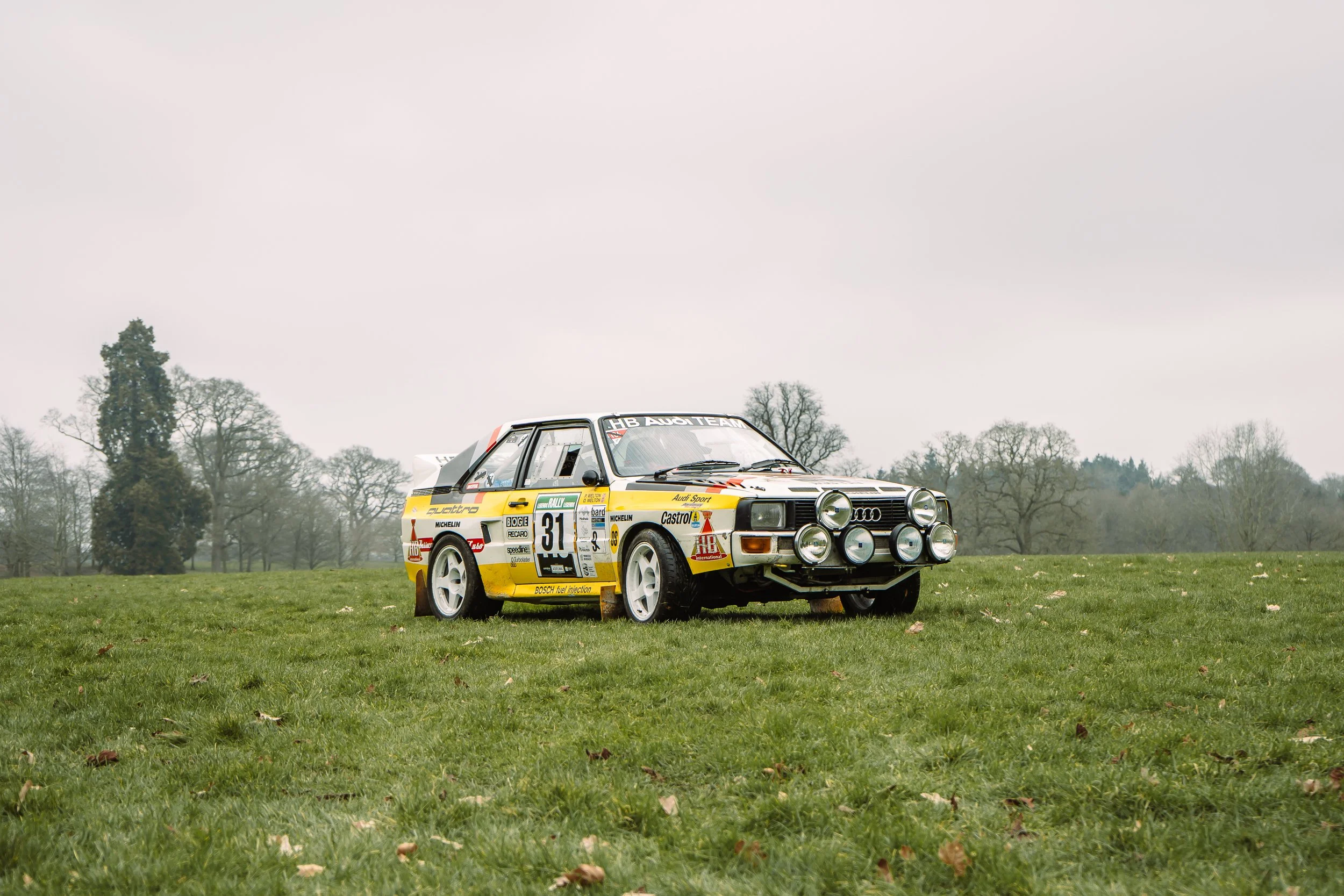 Classic yellow and white rally car on static display at the Lombard Rally Festival