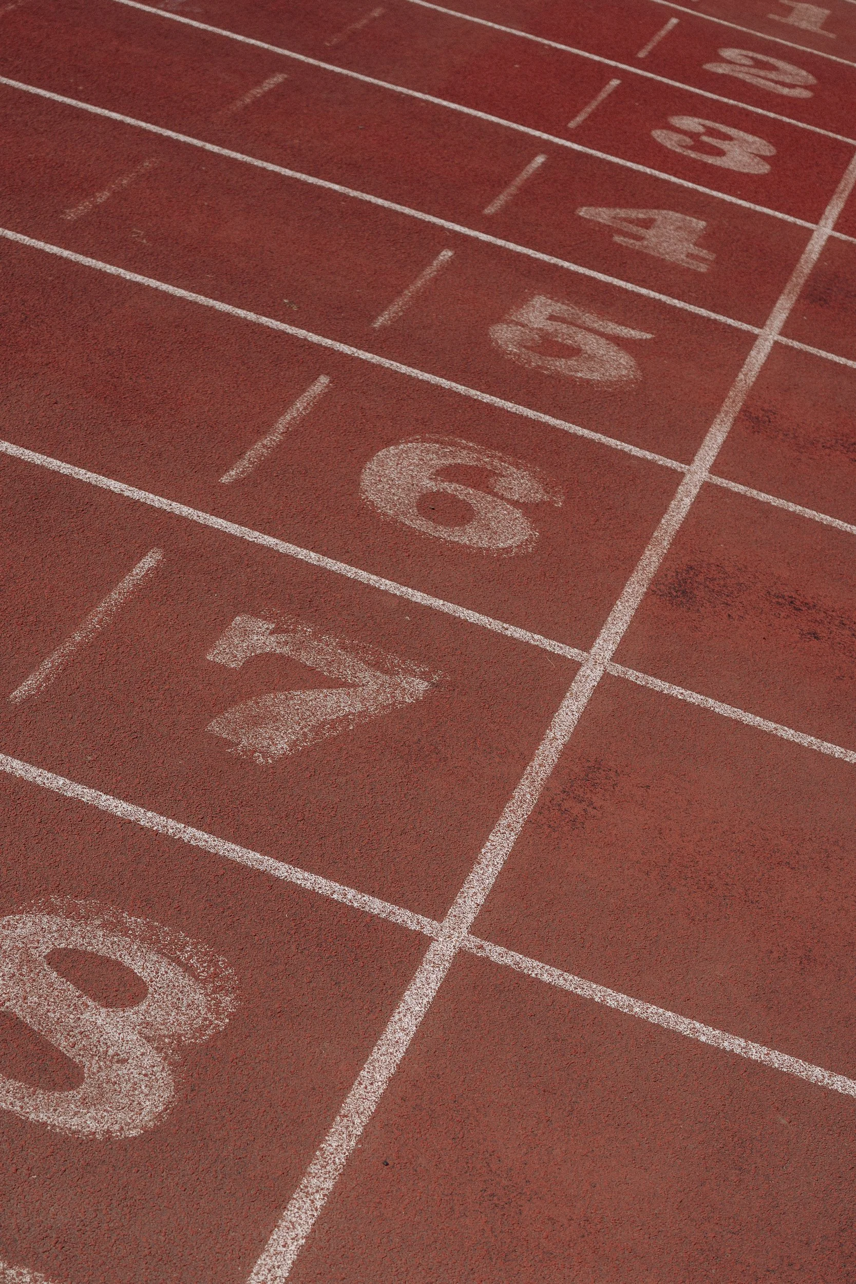 Close-up of running track lane numbers for the Torra Performance Mens Health campaign