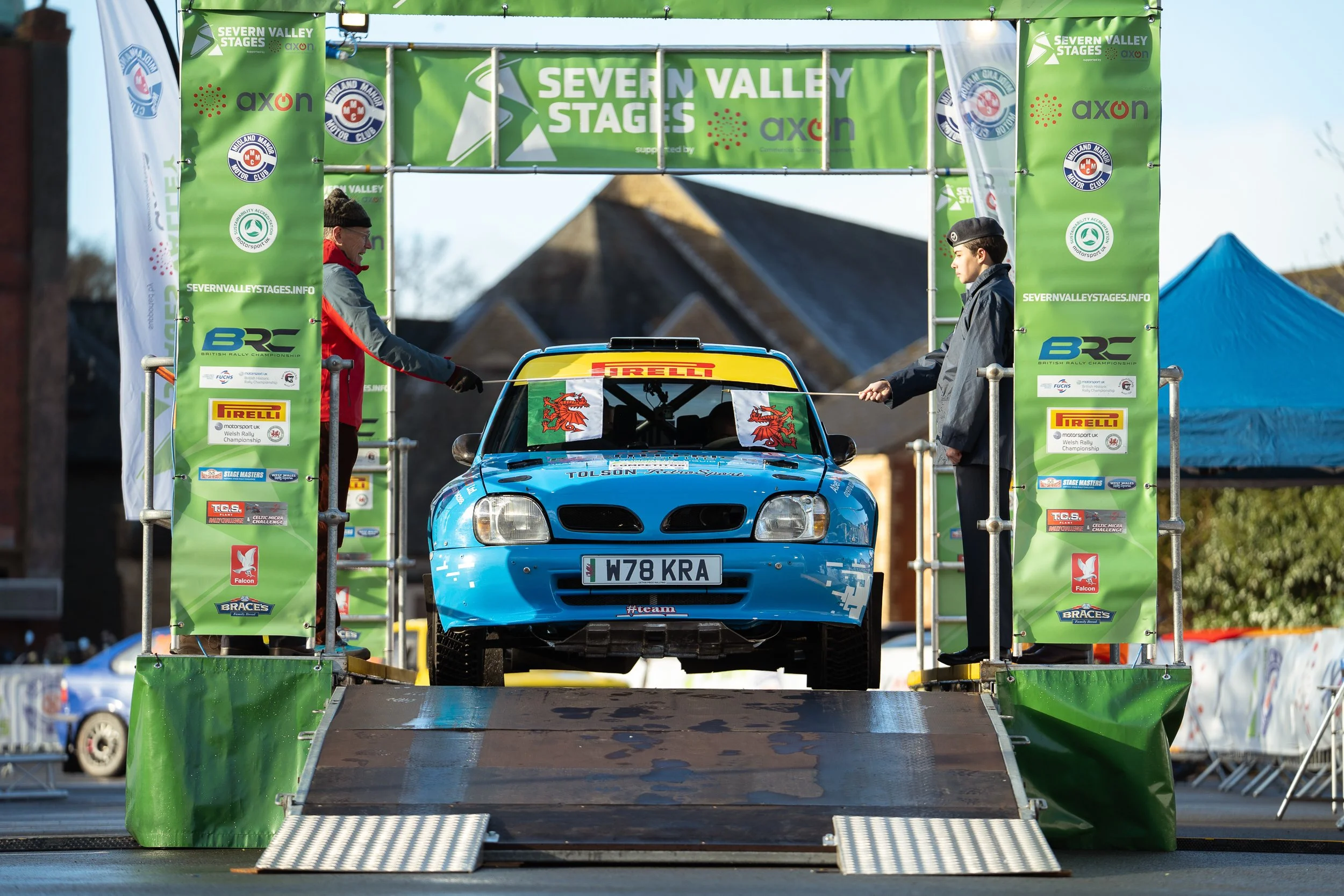 Blue rally car launching from the start ramp at the British Rally Championship Severn Valley Stages