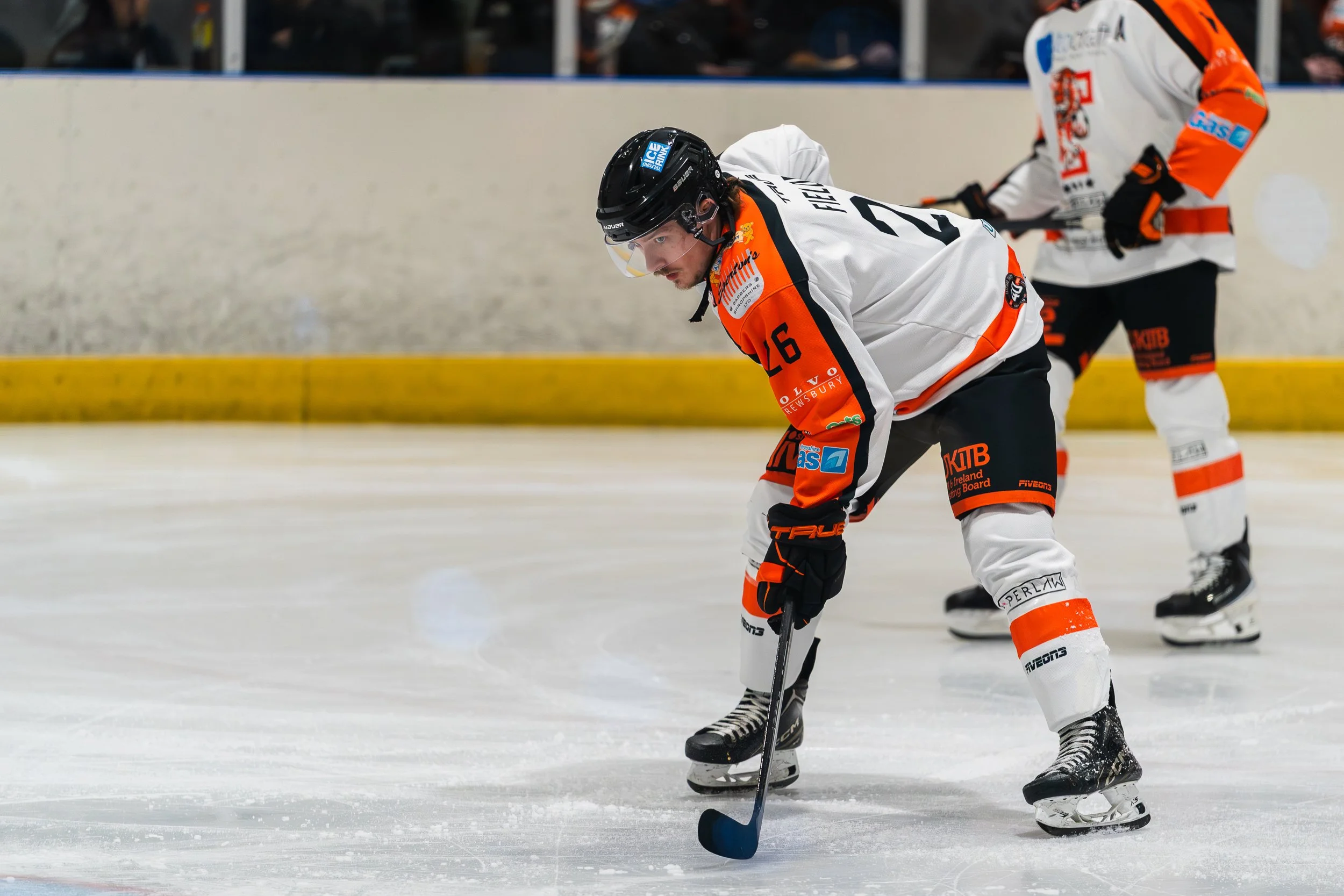 Telford Tigers player controlling the puck with an opponent challenging behind him