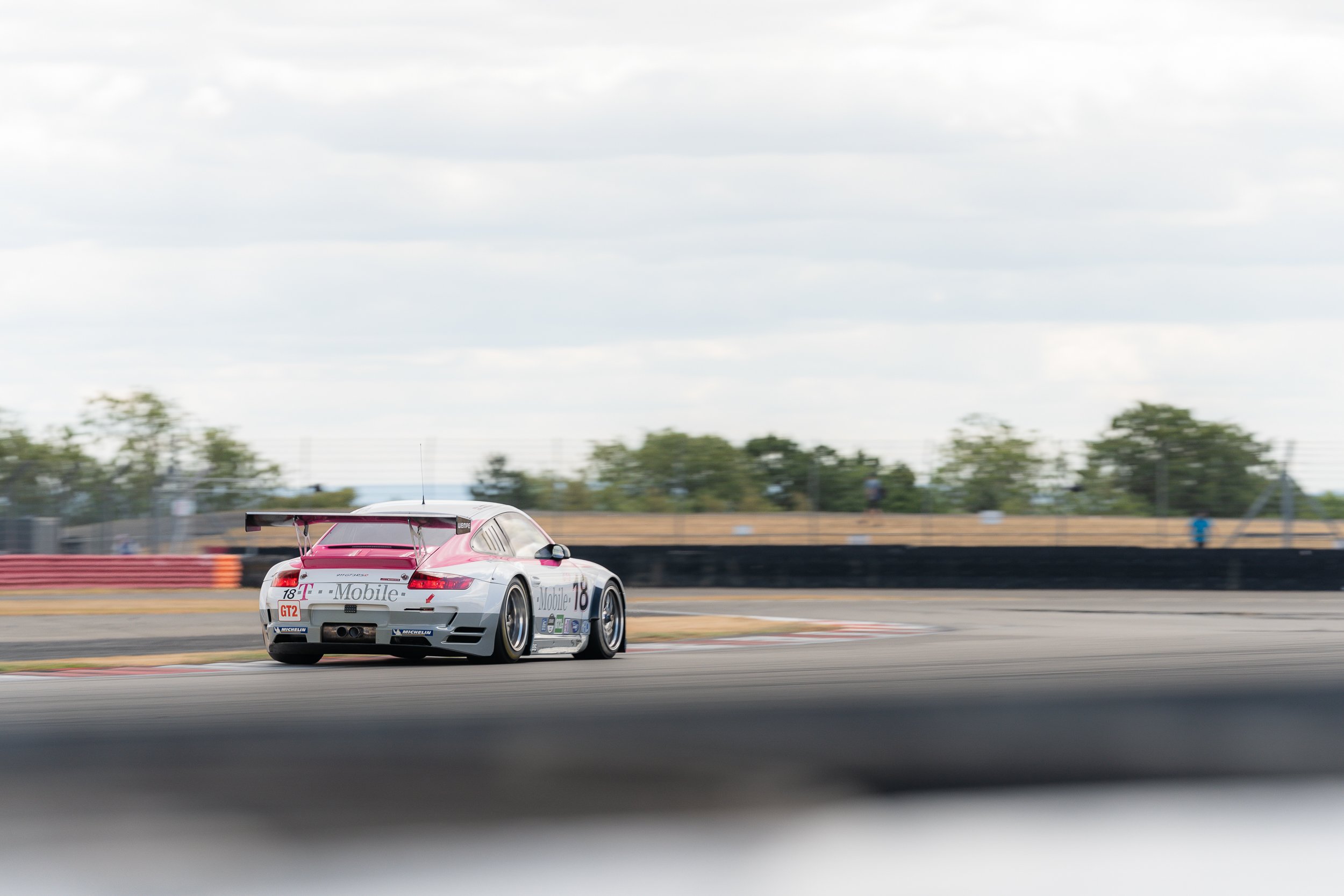 White Porsche GT car with heavy motion blur racing at high speed at the BRDC Classic Silverstone