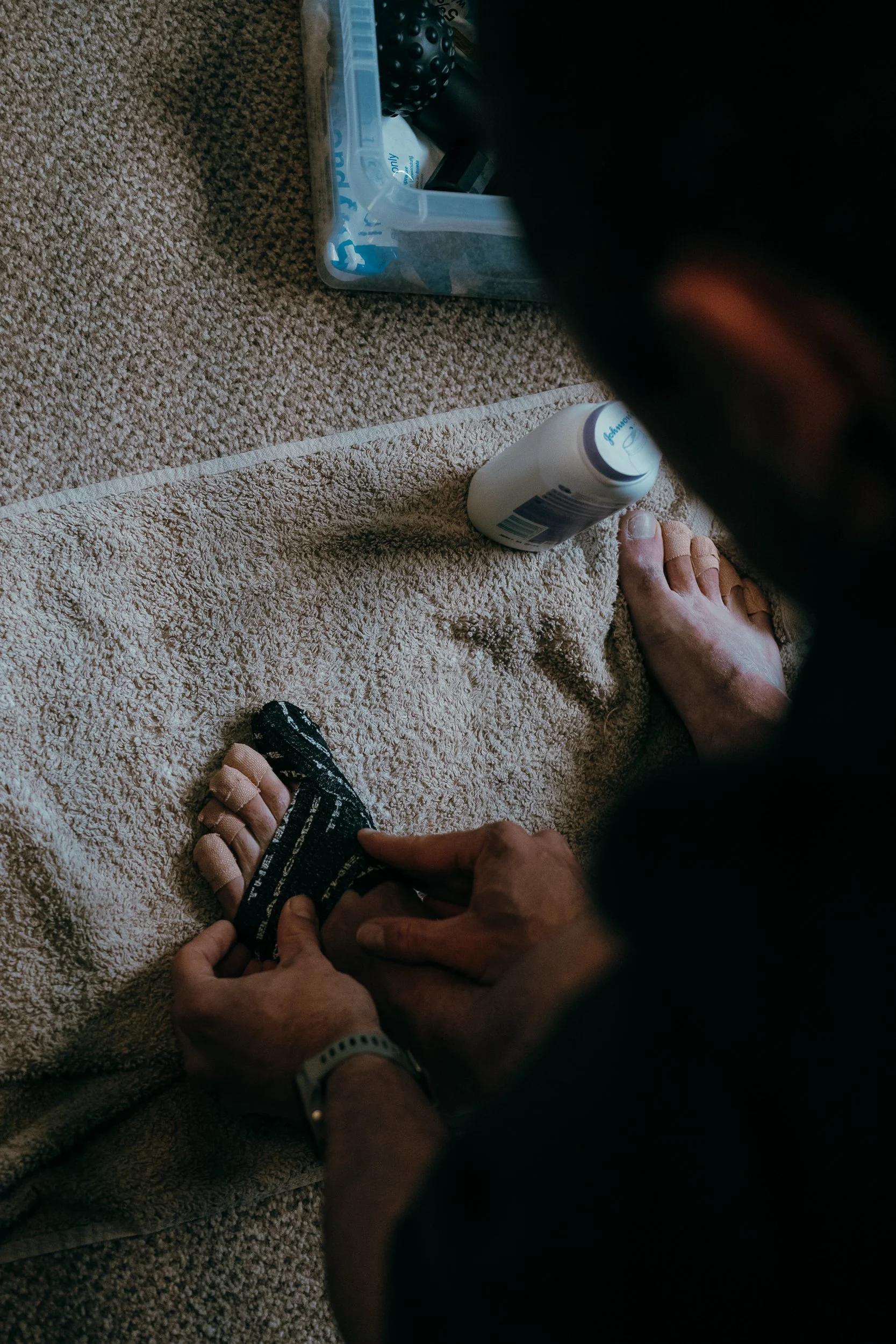 Overhead shot of a runner treating their feet between laps at the Torra Performance REDON Backyard Ultra