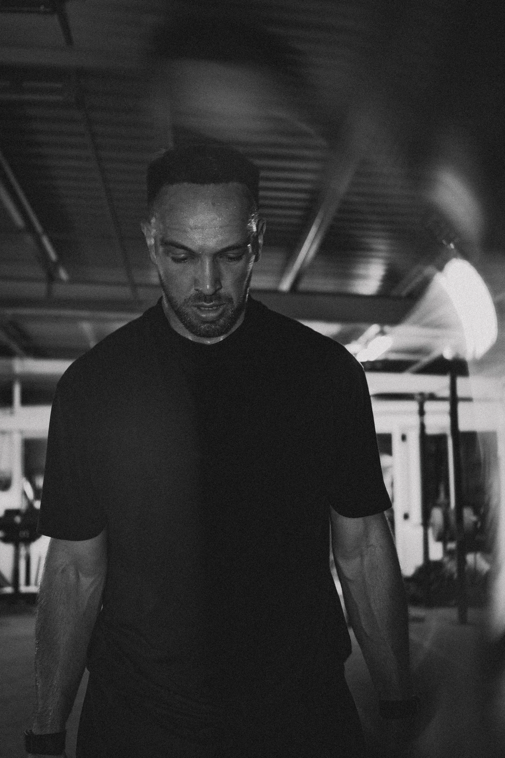 Portrait of a male athlete in dramatic low-key lighting for the Torra Performance Lilleshall campaign