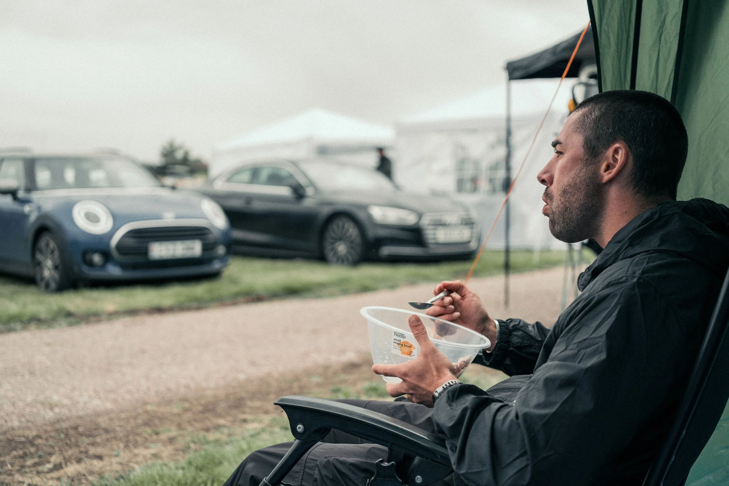Runner eating in a camp chair at the race campsite between laps at the Torra Performance REDON Backyard Ultra