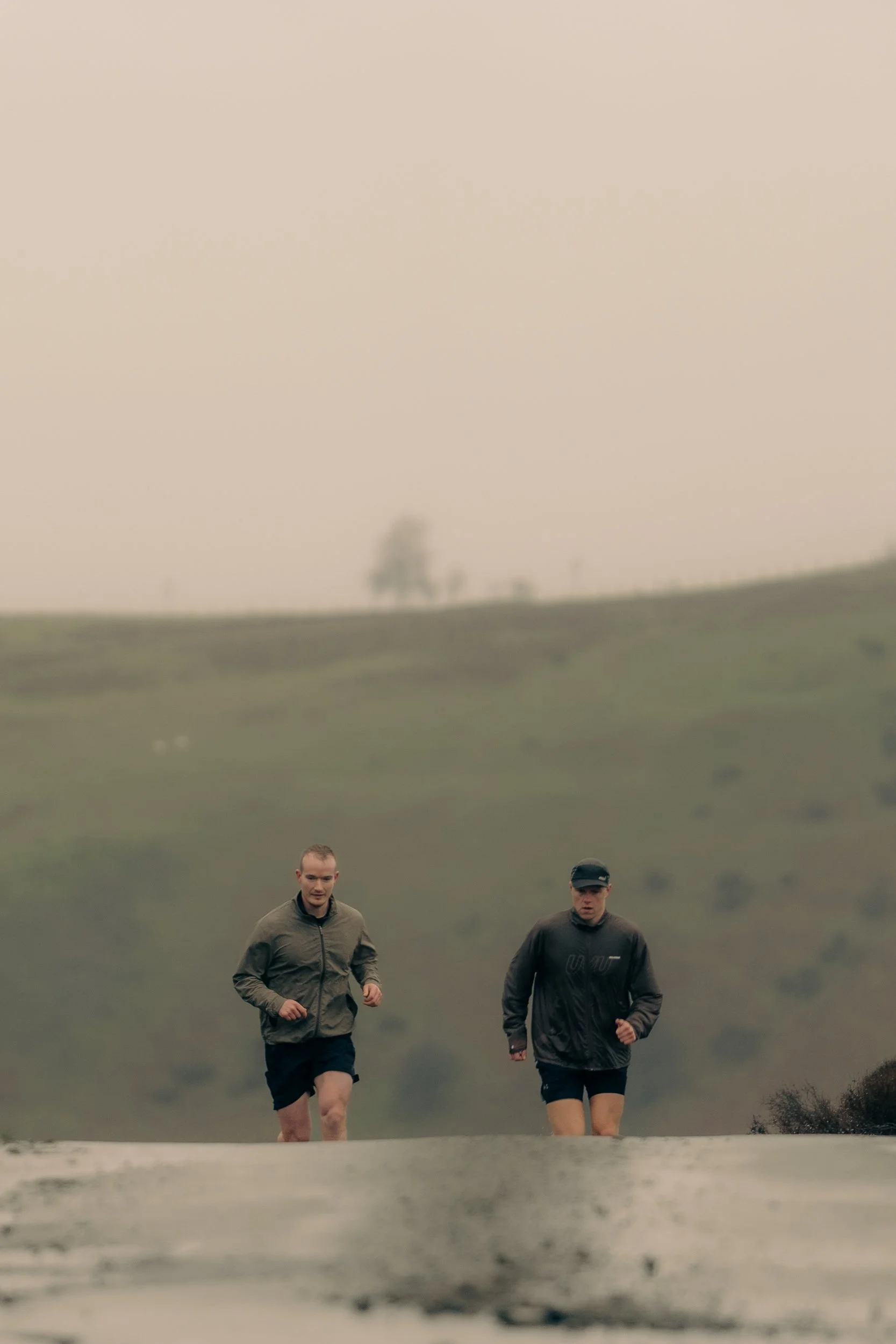 Two runners training on foggy hillside terrain for the Torra Performance Long Mynd campaign