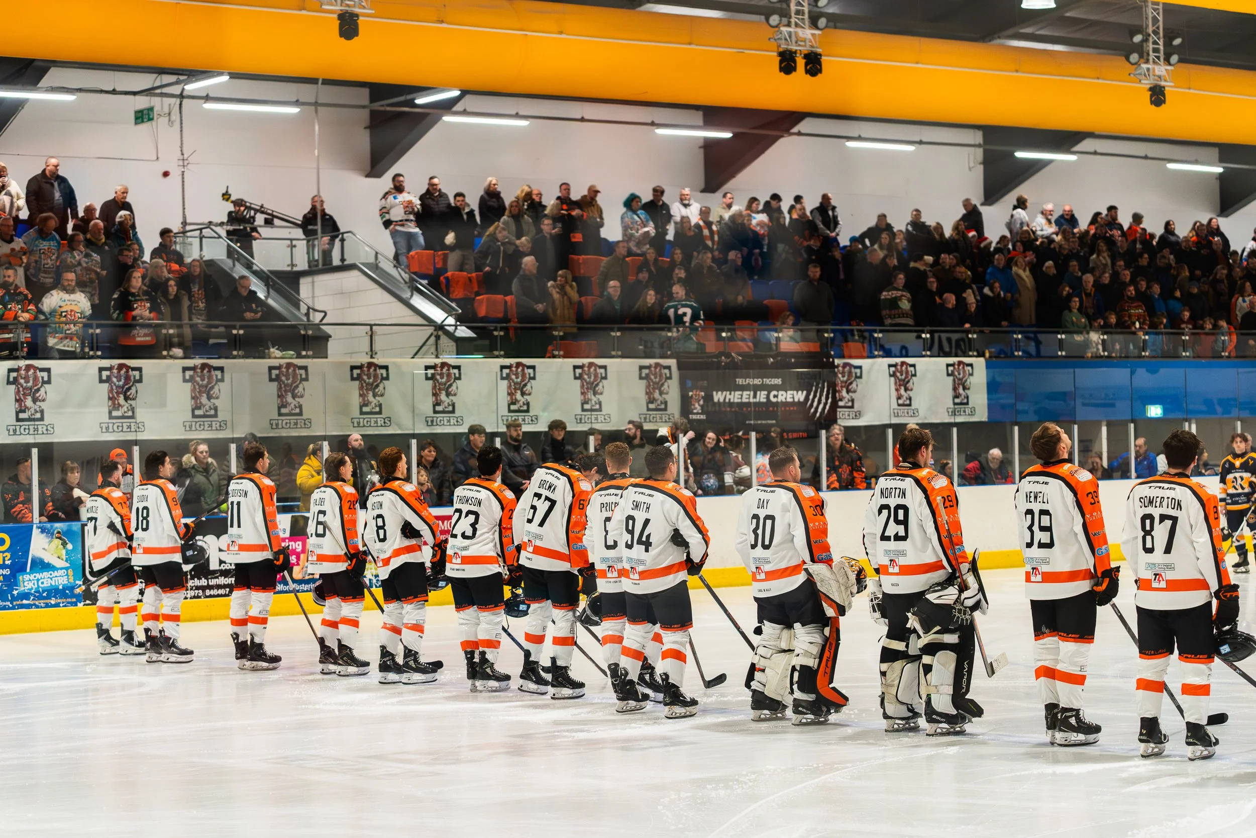 Telford Tigers ice hockey team lined up on the rink before a packed crowd