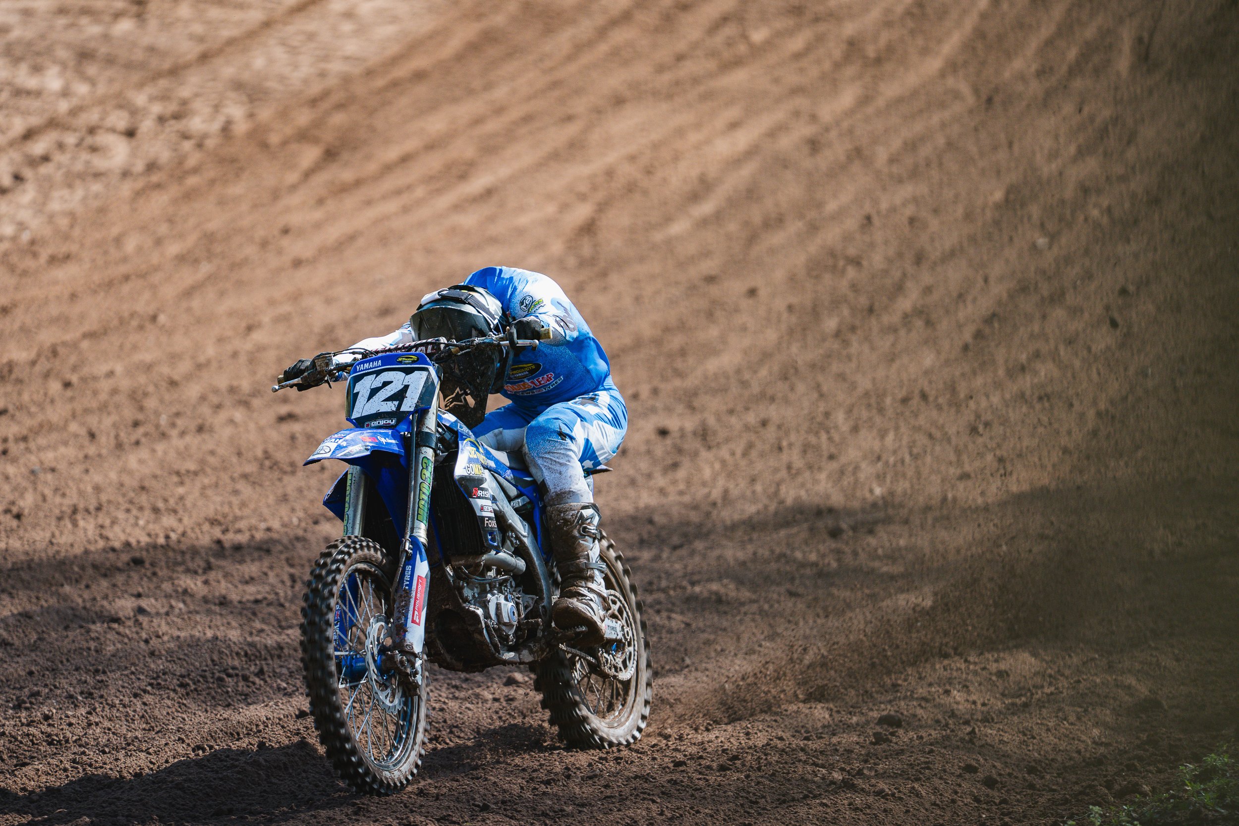 Motocross rider climbing a steep dirt bank at the British Motocross Championship Hawkstone International