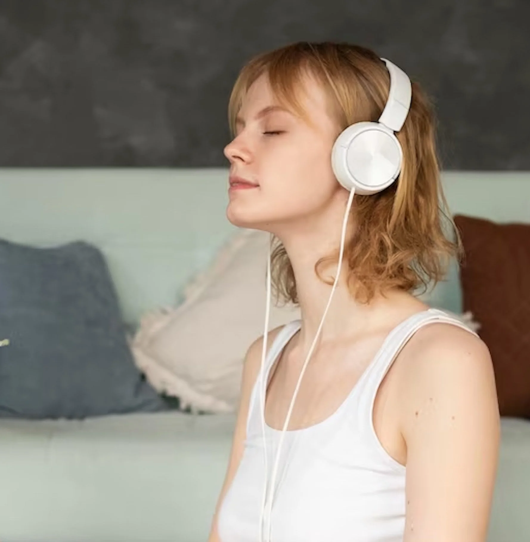 full-shot-woman-meditating-with-headphones_23-2149031302.jpeg