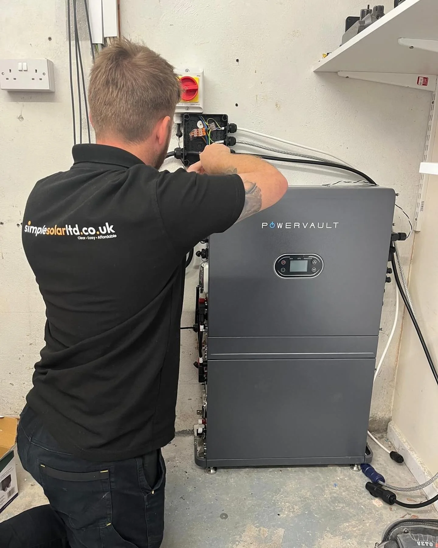 Installer working on equipment indoors.