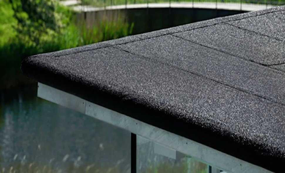 Close-up of a modern flat roof with dark gray granular mineral felt