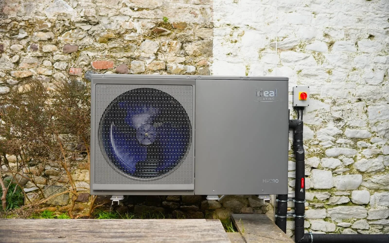 Solar panels on a rural off-grid home in the South West with a Simple Solar van and countryside beyond