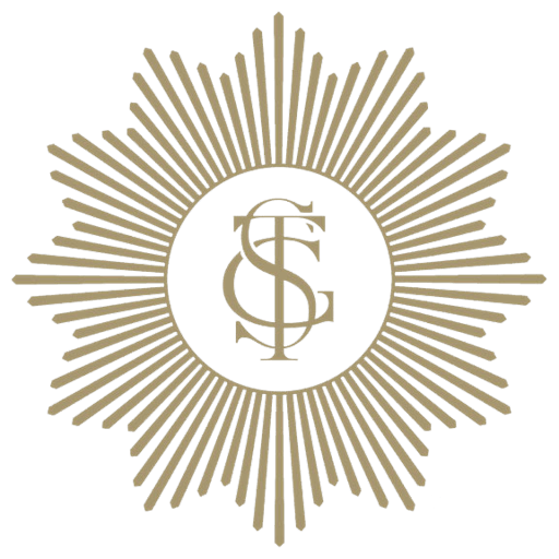 The Scout Guide logo, A symbol with the letters 'T' and 'S' intertwined in the center, surrounded by a starburst design with multiple rays extending outward on a black background.