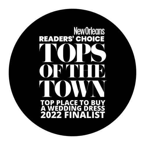 Black circular badge with white text that reads: "New Orleans Readers’ Choice Top of the Town Top Place to Buy a Wedding Dress 2022 Finalist."