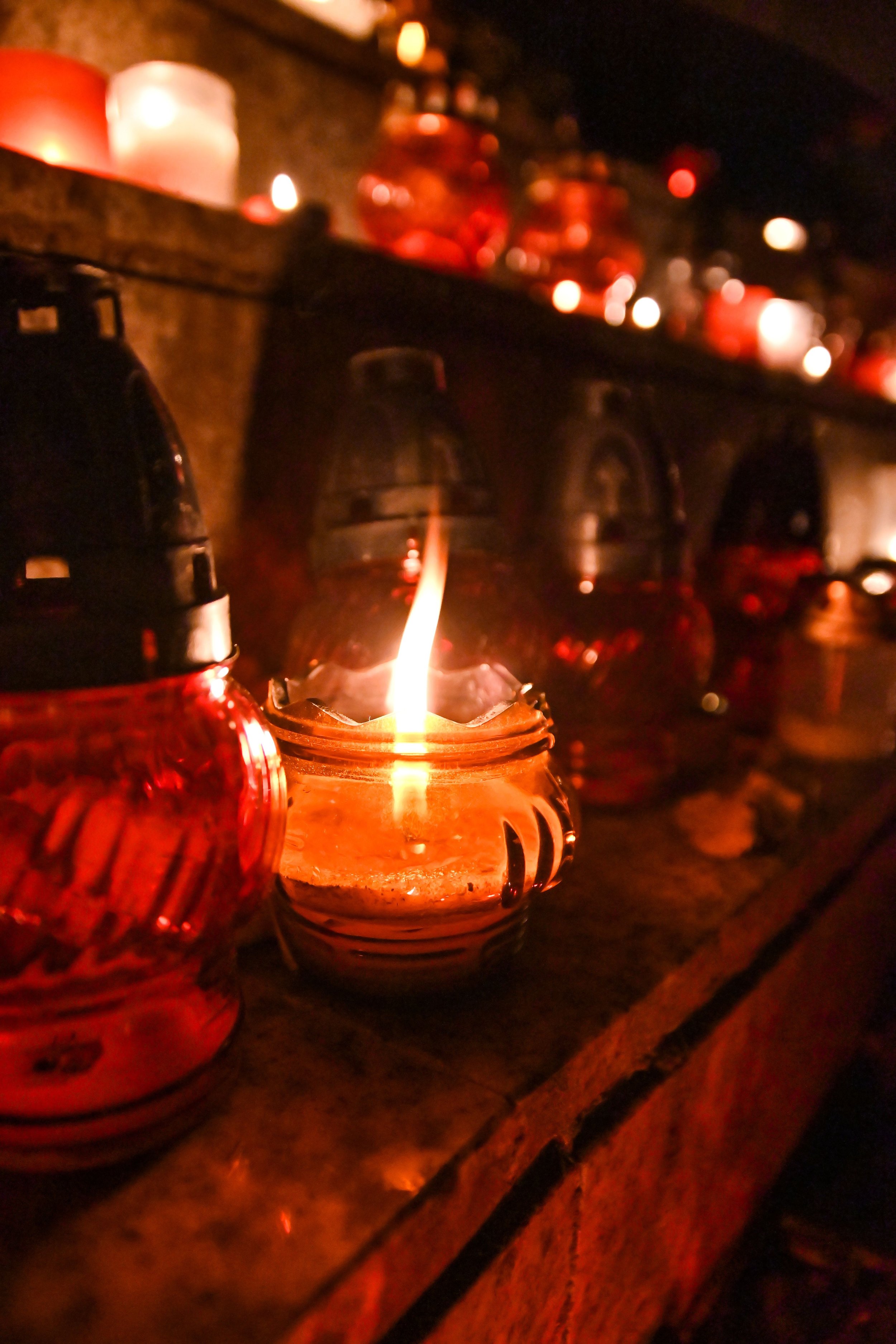 Still life featuring small candles in a warm atmosphere. The candle that is in focus is lit. Credit: Adonyi Gábor