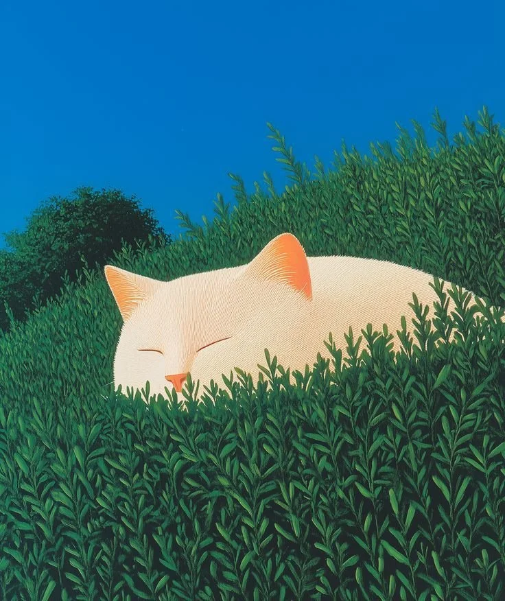A white cat sleeping peacefully in a lush green bush under a bright blue sky.